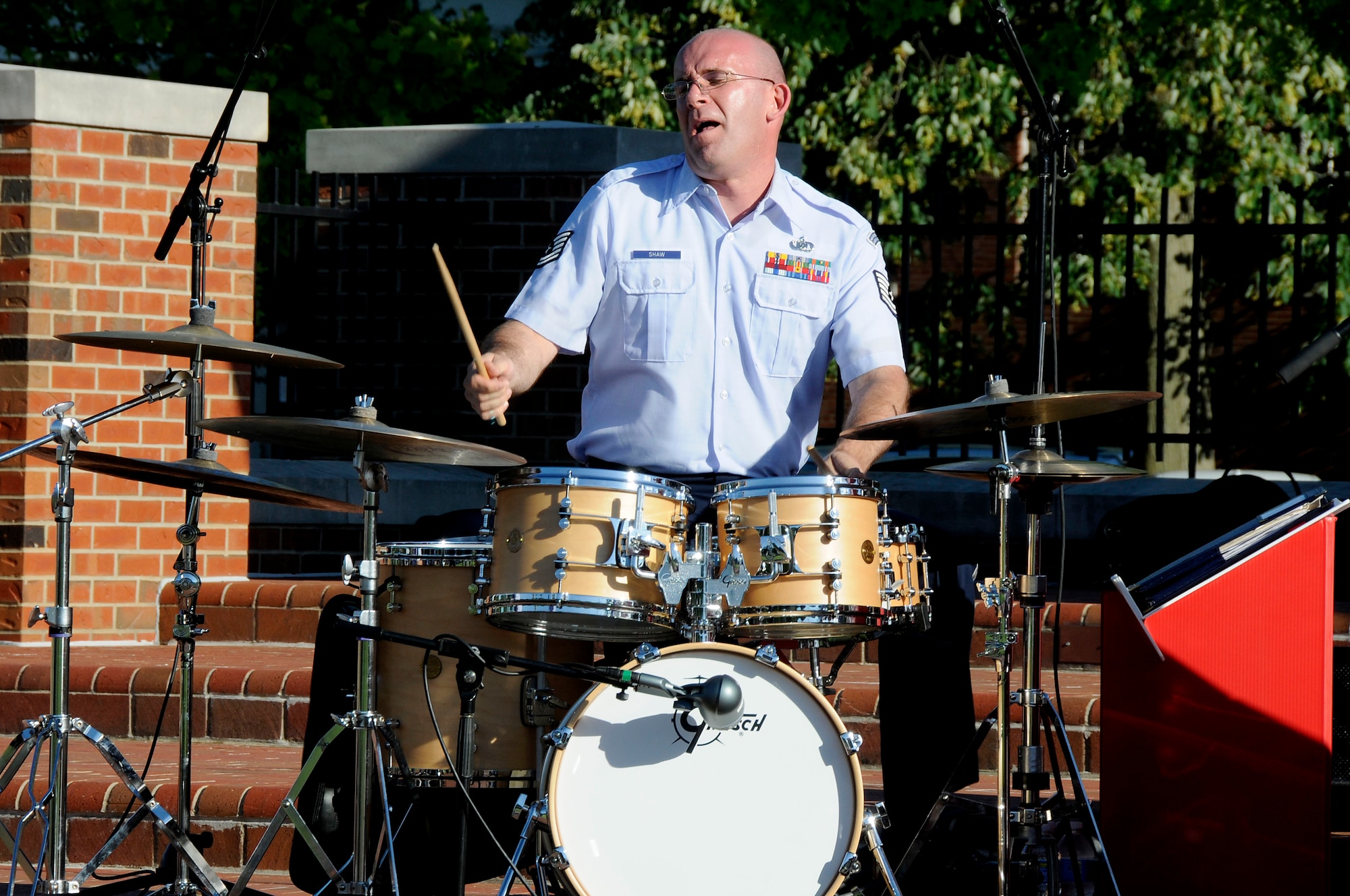 Tech. Sgt. Paul Shaw rocks out on the drums during the United States Air Force Band of Mid-America's concert at Scott AFB parade field, June 6, 2010. The Shades of Blue Jazz Ensemble performed in front of Team Scott to kick off the summer concert series. Upcoming performances in the summer concert series include Starlifter, Aug. 1, and the concert band Aug. 29. (U.S. Air Force photo by Staff Sgt. Brian J. Ellis)