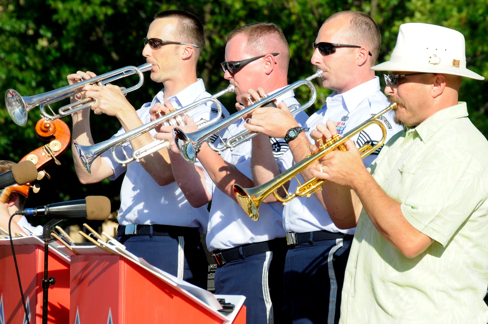 The trumpet section plays during the United States Air Force Band of Mid-America's concert at Scott AFB parade field, June 6, 2010. The Shades of Blue Jazz Ensemble performed in front of Team Scott to kick off the summer concert series. Upcoming performances in the summer concert series include Starlifter, Aug. 1, and the concert band Aug. 29. (U.S. Air Force photo by Staff Sgt. Brian J. Ellis)