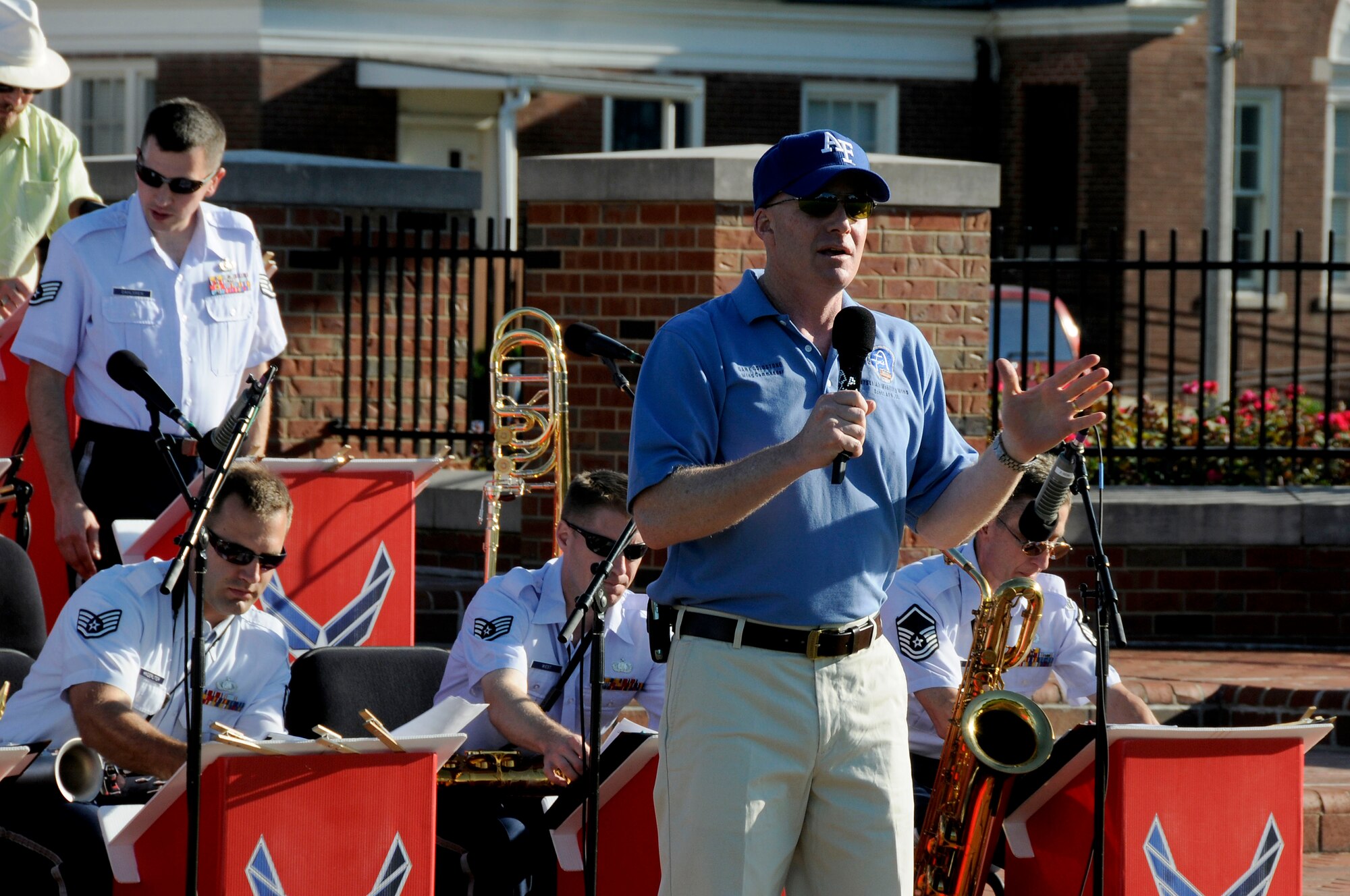 Col. Gary Goldstone, 375th Air Mobility Wing commander, gives opening remarks at the United States Air Force Band of Mid-America's concert at Scott AFB parade field, June 6, 2010. The Shades of Blue Jazz Ensemble performed in front of Team Scott to kick off the summer concert series. Upcoming performances in the summer concert series include Starlifter, Aug. 1, and the concert band Aug. 29. (U.S. Air Force photo by Staff Sgt. Brian J. Ellis)