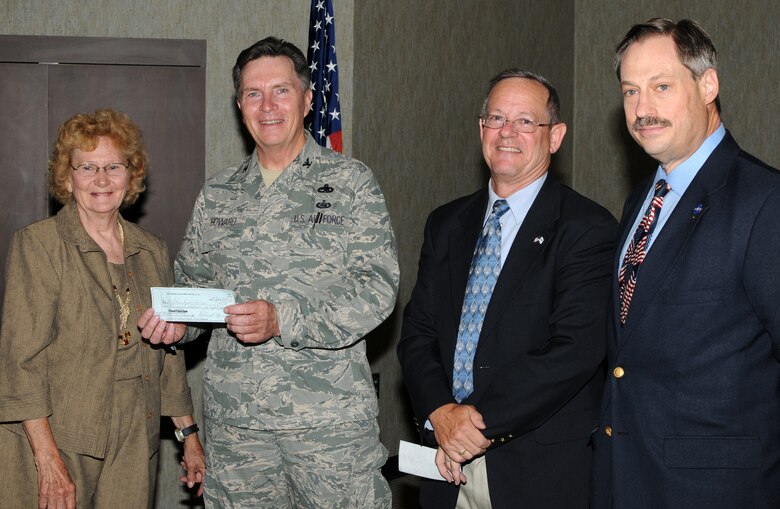 McGHEE TYSON AIR NATIONAL GUARD BASE, Tenn. -- Leadership from the local Gen. Bruce K. Holloway Air Force Association Chapter present a check for $2,000 to the McGhee Tyson Inn for installation of wireless internet services, June 3.  From L-R are Polly Morrisey, AFA treasurer; Col. Richard B. Howard, commander of The I.G. Brown Air National Guard Training and Education Center; Jim Mungenast, AFA president; and Joe Jarret, AFA membership. (U.S. Air Force photo by Master Sgt. Mavi Smith/Released)