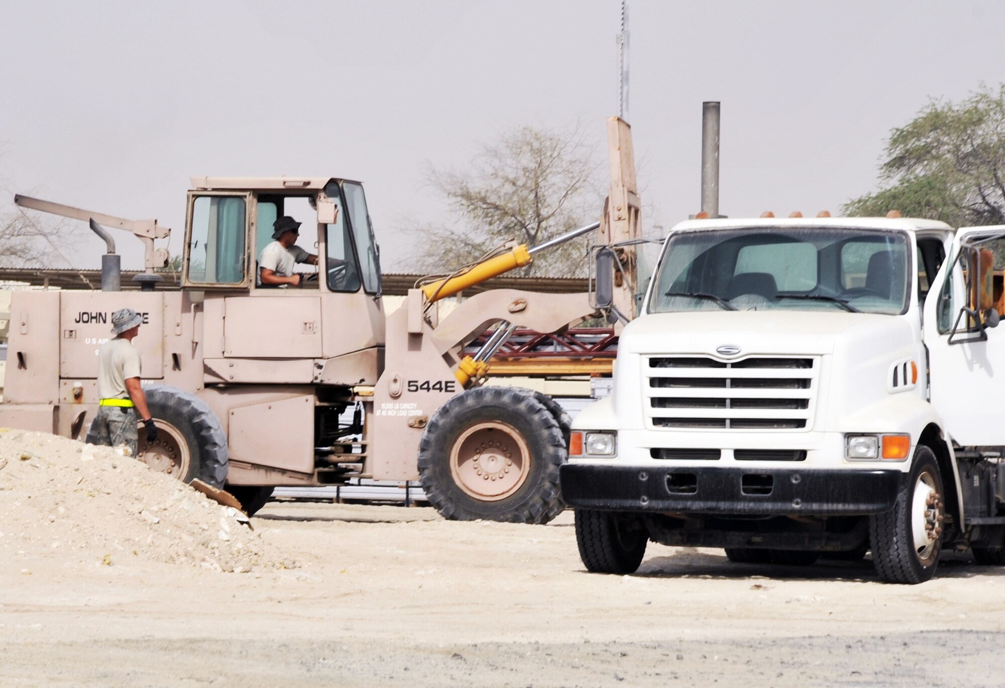 Airmen from the 380th Expeditionary Civil Engineer Squadron load a tractor-trailer with new infrastructure equipment during operations for the 380th Air Expeditionary Wing June 11, 2010, at a non-disclosed base in Southwest Asia. Civil engineering Airmen having been working continuously for more than two months on multi-million dollar upgrades to airfield structures and other infrastructure projects for the 380th AEW.  The new structures, officials say, will allow for increased efficiency in airfield and base operations. The 380th AEW supports operations Iraqi Freedom and Enduring Freedom and the Combined Joint Task Force-Horn of Africa. (U.S. Air Force Photo/Master Sgt. Scott T. Sturkol/Released)
