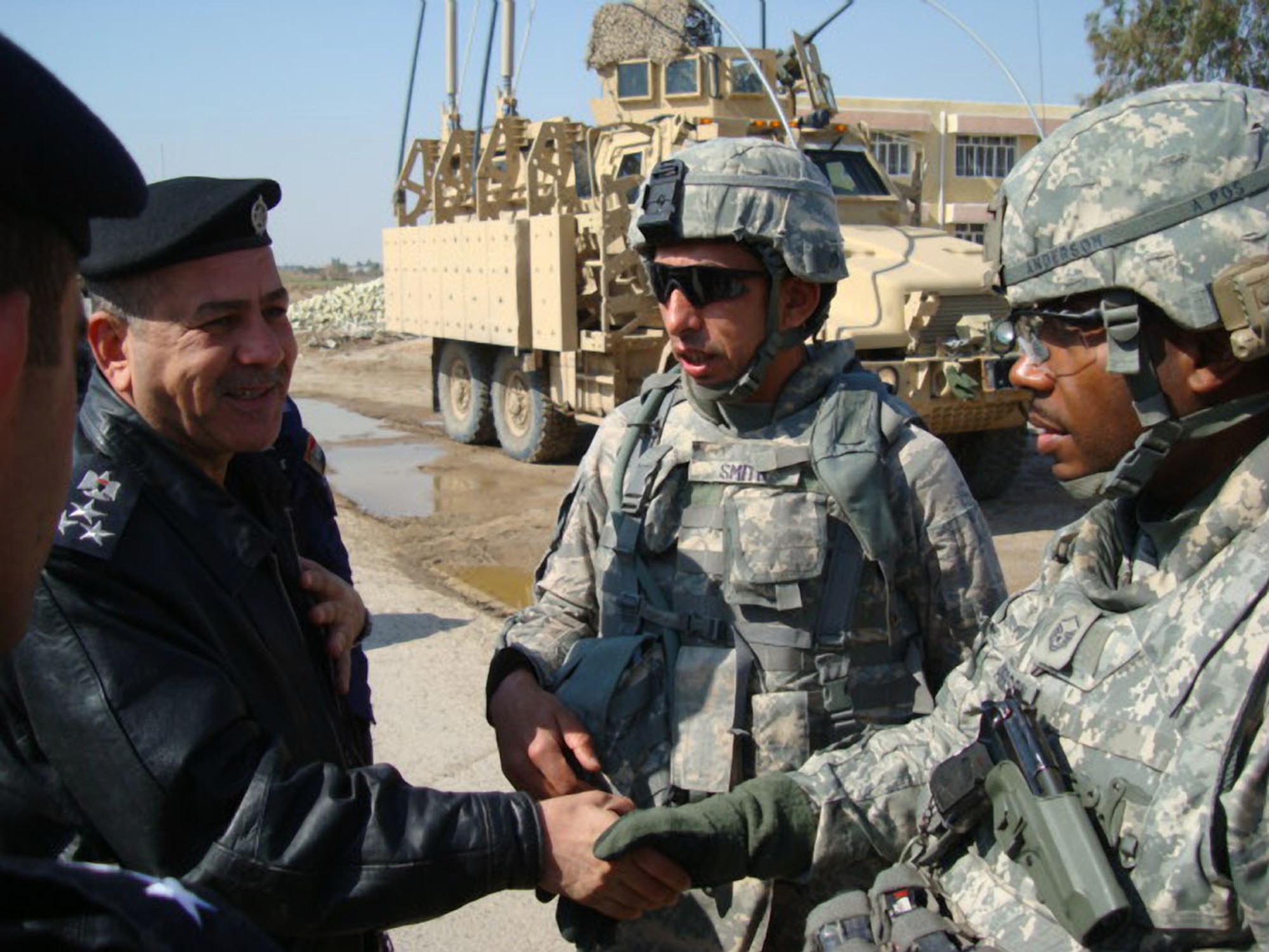 Defenders from the 732nd Expeditionary Security Forces Squadron, Detachment 3, meet with Brig. Gen. Emad Ismael Al Shafi, Taji District Police commander, prior to conducting a joint patrol into a market area. At the Taji Law Enforcement Academy at Camp Taji, Iraq, these defenders advised and assisted Iraqi Police officers in their training of the Iraqi Police. The academy closed June 3, 2010, as a local training academy, but training will continue at the directorate level at a regional training center in Baghdad. (Photo courtesy of the 732nd ESFS, Det. 3/Released)