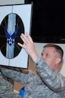 HANSCOM AIR FORCE BASE, Mass. – Col. James Lovell, acting commander of the 551st Electronic Systems Wing, holds up a gift for everyone to see at his farewell luncheon in Building 1612’s atrium on June 8. Colonel Lovell will become the deputy director for the Global Power Programs office of the Assistant Secretary of the Air Force for Acquisition at the Pentagon. (U.S. Air Force photo by Rick Berry)