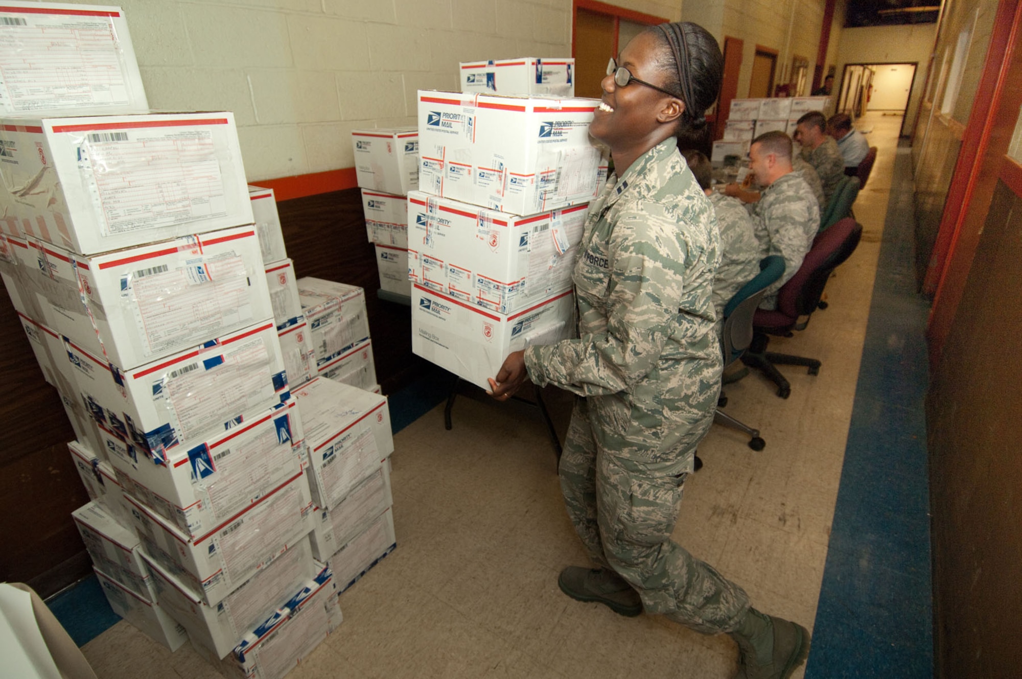 HANSCOM AIR FORCE BASE, Mass. – Capt. Tchoia Brown stacks assembled care packages during the Company Grade Officers Council’s Troop Care Drive on June 3.  Twenty-five volunteers assembled approximately 200 care packages for deployed troops and prepared them for shipping from 8 a.m. to 4 p.m. in Building 1105A. (U.S. Air Force photo by Rick Berry)