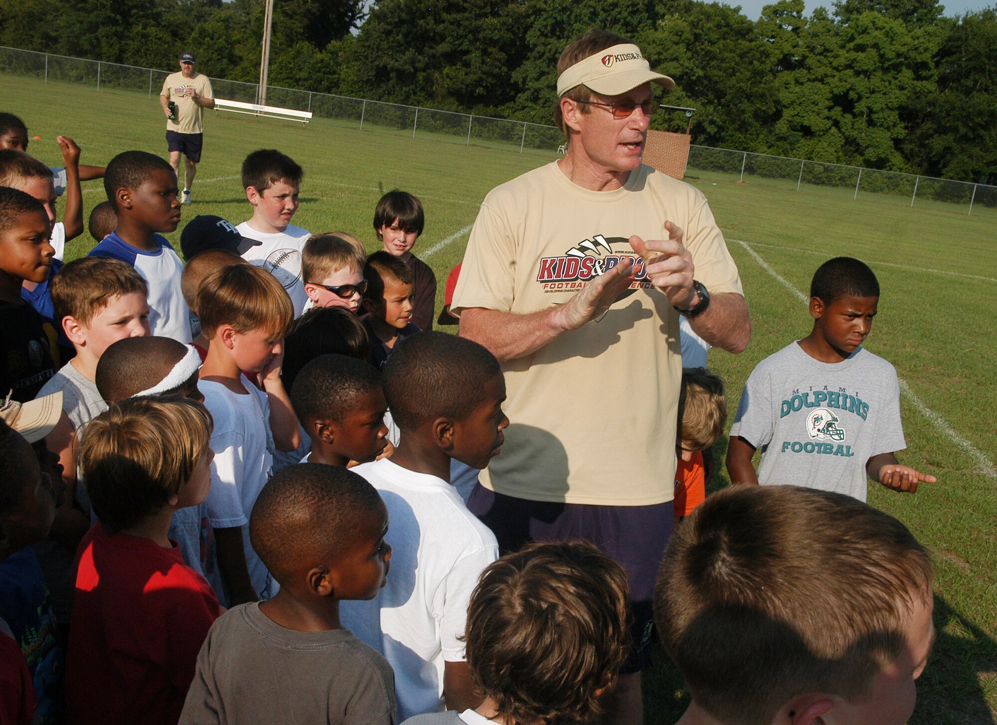 Buddy Curry, Atlanta Flacons inside linebacker, 1980-1987, talks to participants in the Kids & Pros Youth Football Camp. U. S. Air Force photo by Sue Sapp