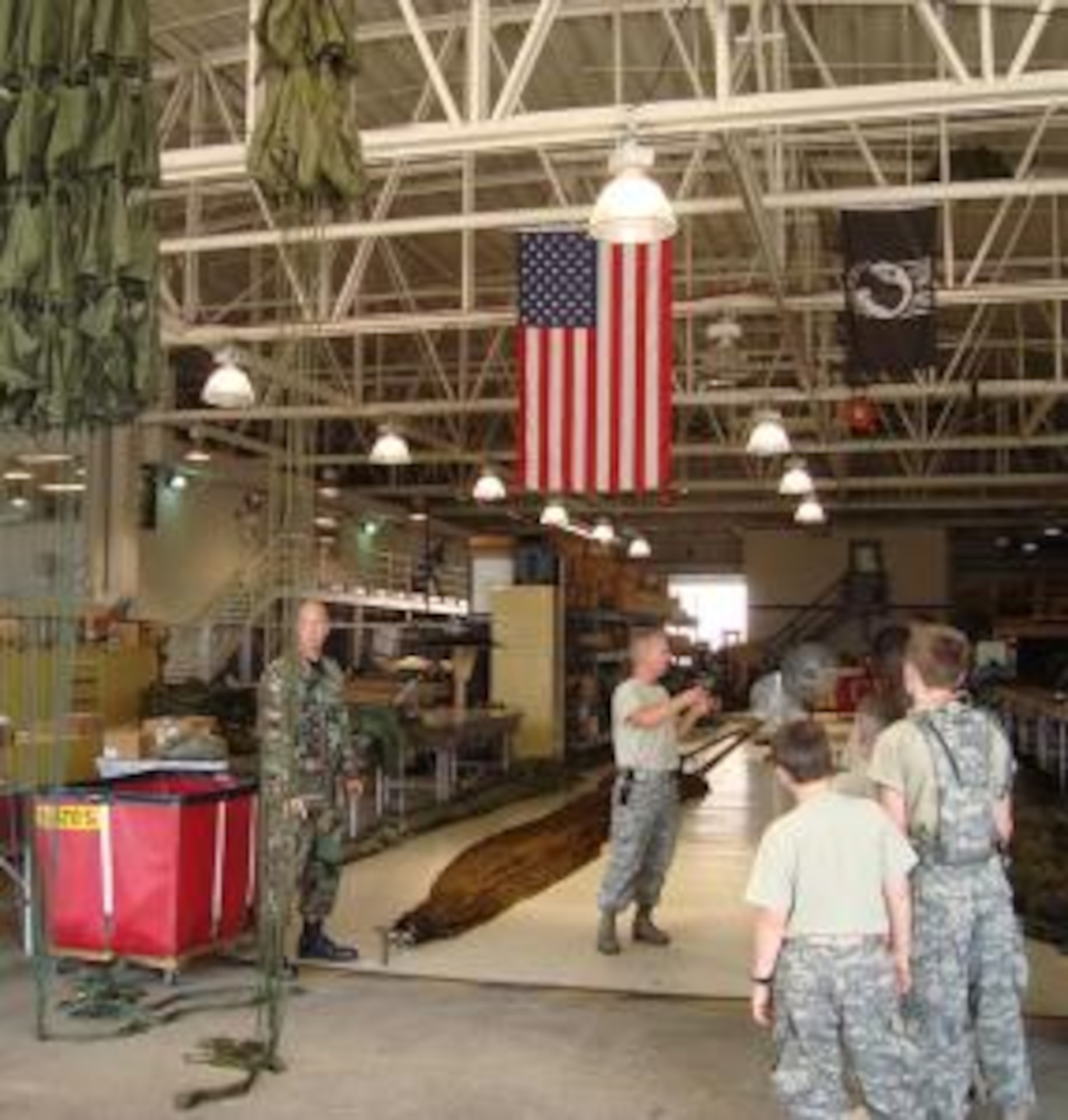 Twelve students  between the ages of 12-17 participated in the U.S. Army Cadet Corps familiarization training program at Dobbins June 5.  Staff Sgts. Beaver and Criswell led the small detachment around the Aerial Delivery Flight hangar answering questions and showing off the airdrop assets. The cadets demonstrated how the different cargo parachutes would arrive to the troops in the field.  (photo by Bior B. Bropleh)
