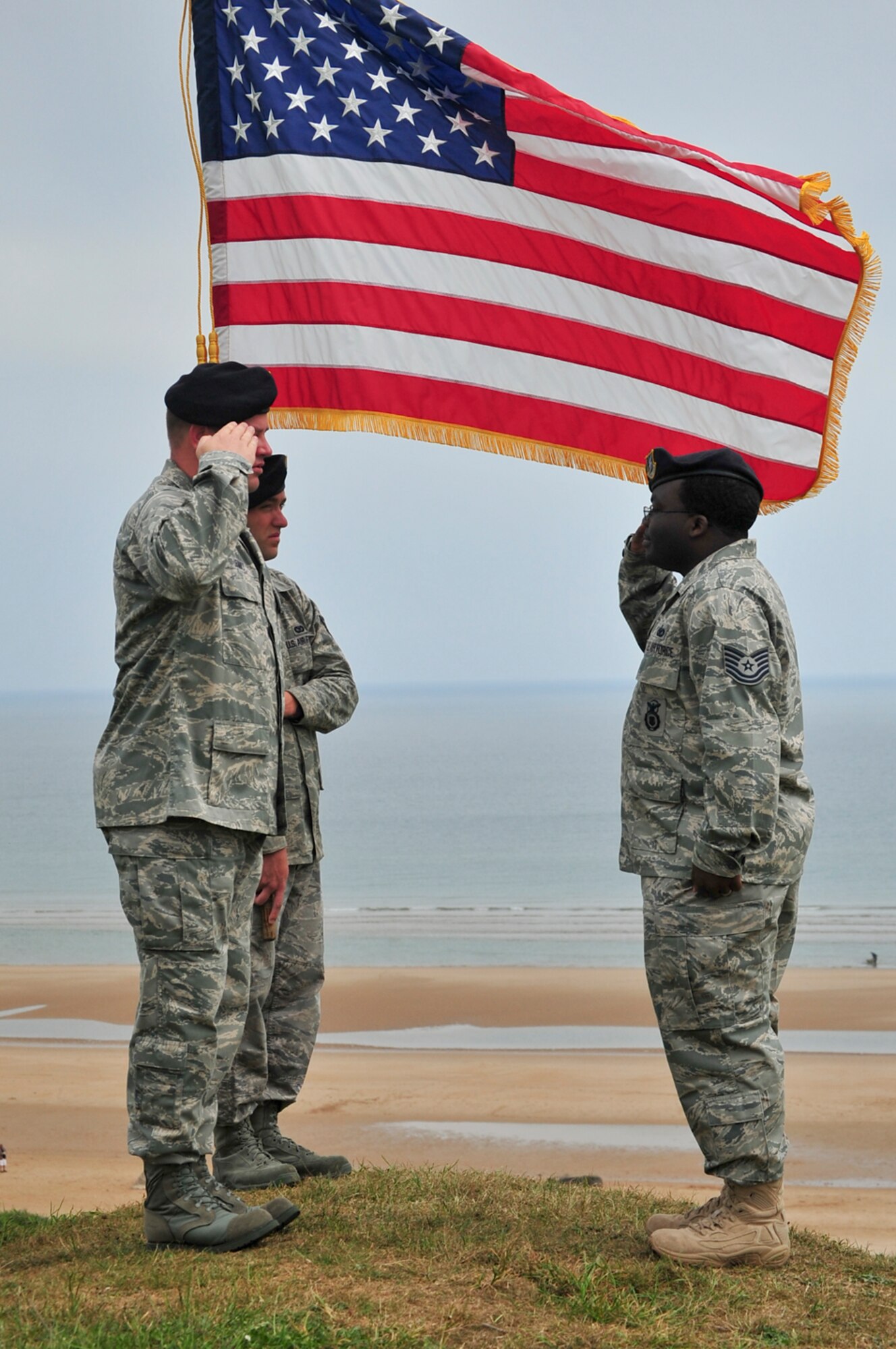 NORMANDY, France – Tech. Sgt. Kendall Bell, right, 701st Munitions Support Squadron custody forces, salutes, Capt. Andrew Legault, 701st MUNSS custody forces chief, after reenlisting June 6. Sergeant Bell has served in the Air Force for about 11 years and is originally from New Orleans, La. (courtesy photo/Ruth Dias)