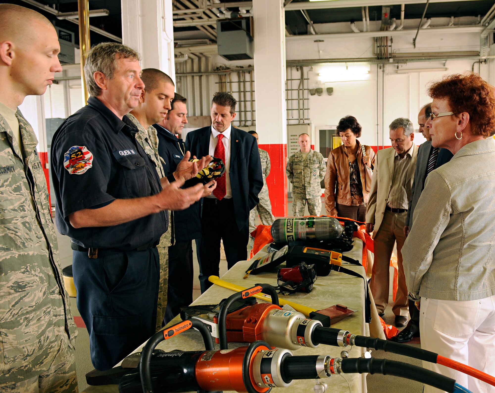 SPANGDAHLEM AIR BASE, Germany – Firefighters from the 52nd Civil Engineer Squadron, left, explain the purpose of various pieces of equipment to visitors June 10. German, Bulgarian and Romanian fire and emergency responders visited the base to exchange ideas and strengthen relationships. (U.S. Air Force photo/Senior Airman Benjamin Wilson)
