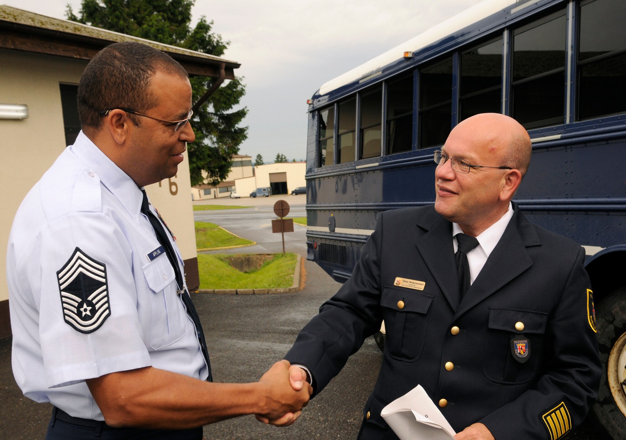 SPANGDAHLEM AIR BASE, Germany – Chief Master Sgt. Robert Appling, 52nd Civil Engineer Squadron fire chief, greets Heinz Wolschendorf, Trier District Fire Department director, at the fire department here June 10. German, Bulgarian and Romanian fire and emergency responders visited the base to exchange ideas and strengthen relationships. (U.S. Air Force photo/Senior Airman Benjamin Wilson)
