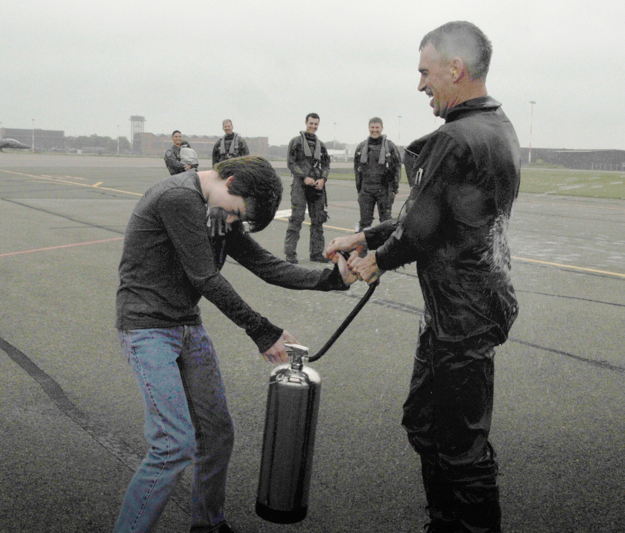 Col. Lawerence Reed, 48th Fighter Wing vice commander, sprays his son Mathew, 13, with water after arriving from his fini-flight at RAF Mildenhall on June 10. Colonel Reed is headed to Langley Air Force Base, Va. (U.S. Air Force photo/Airman 1st Class Eboni Knox)