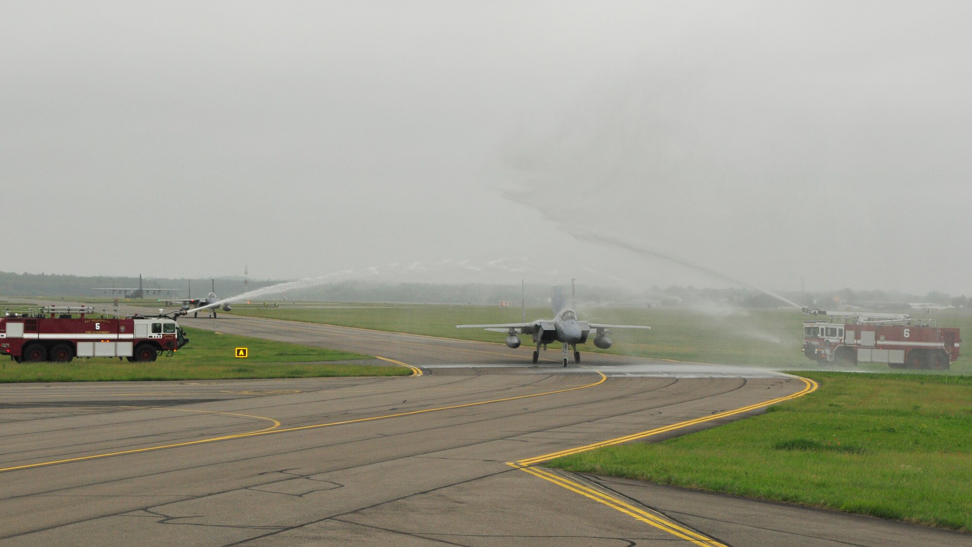 Col. Lawerence Reed, 48th Fighter Wing vice commander, is sprayed by fire trucks while taxing in from his fini-flight at RAF Mildenhall on June 10. After two years as Liberty Wing vice commander he’s headed to Langley Air force Base, Va. (U.S. Air Force photo/Airman 1st Class Eboni Knox)