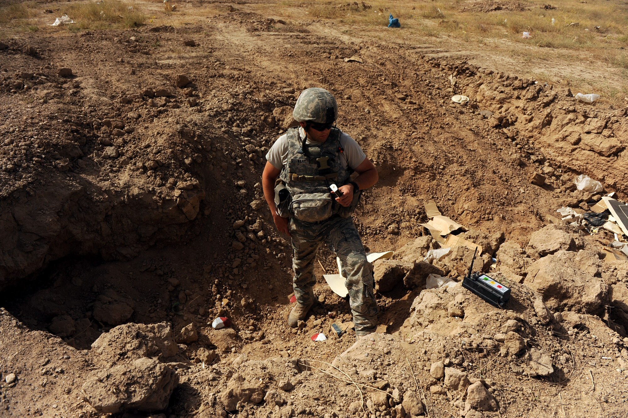 Staff Sgt. Benjamin Stewart, an explosive ordnance disposal technician assigned to the 755th Air Expeditionary Squadron, Operating Location-Bravo EOD, places C-4 explosives to destroy M-42 bomblets June 4, 2010, in Kandahar City, Afghanistan. Airmen from the 755th AES OL-Bravo EOD are making a difference by clearing bombs from land near Kandahar Airfield to help make it safe for a future regional military training center site for the Afghan National Army. (U.S. Air Force photo/ Staff Sgt. Manuel J. Martinez/released)
