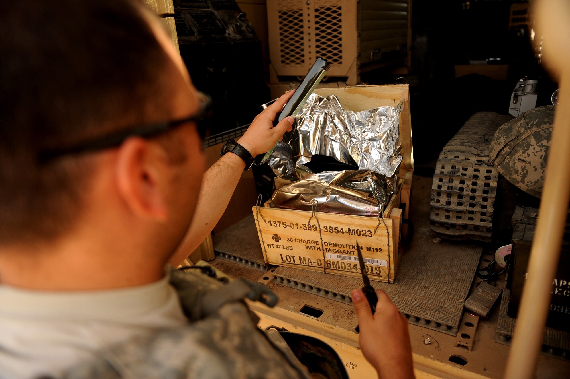 Staff Sgt. Benjamin Stewart, an explosive ordnance disposal technician assigned to the 755th Air Expeditionary Squadron, Operating Location-Bravo EOD, opens a box of C-4 explosives, which will be used to destroy M-42 bomblets June 4, 2010, in Kandahar City, Afghanistan. (U.S. Air Force photo/ Staff Sgt. Manuel J. Martinez/released)
