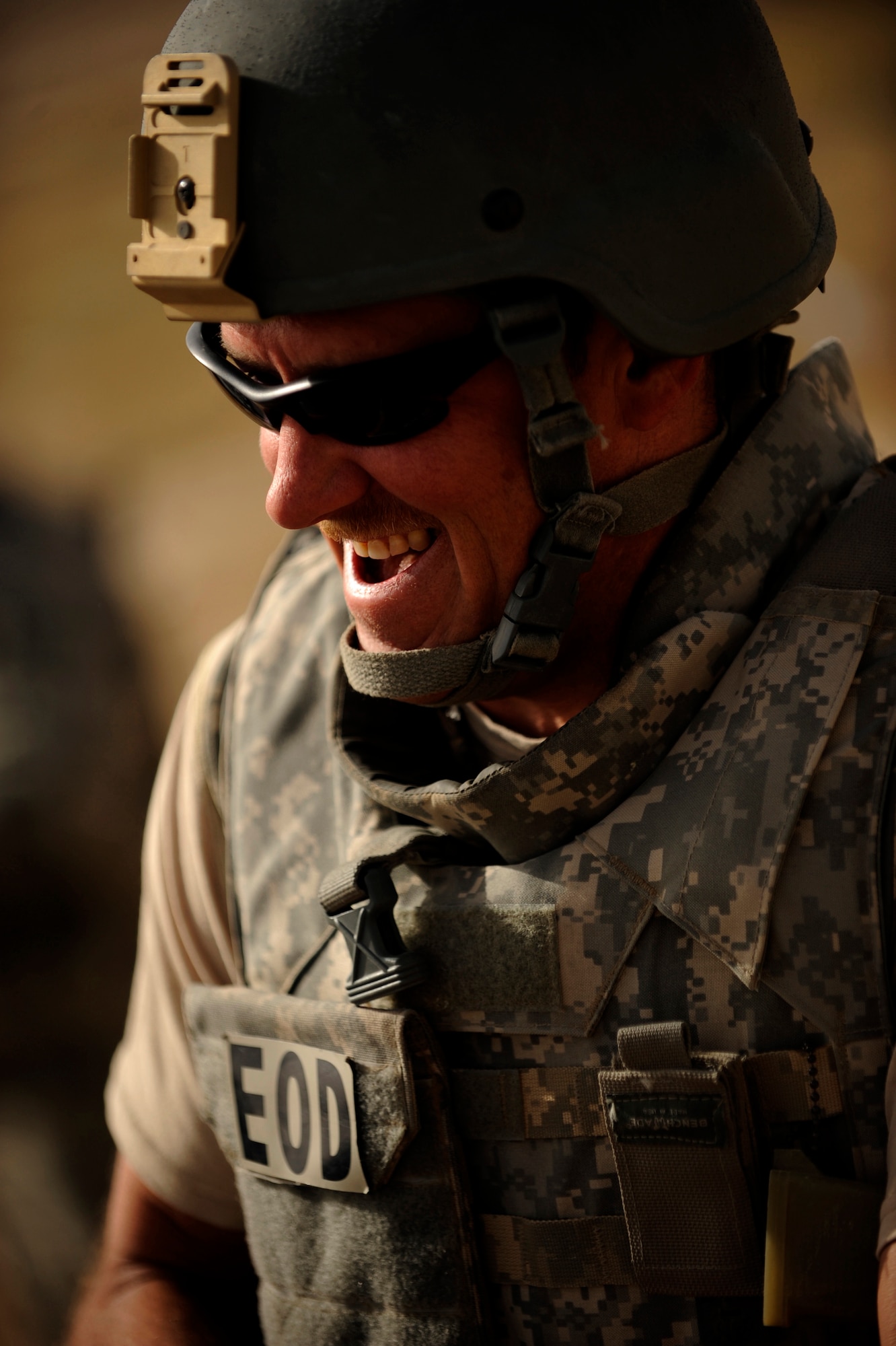 Master Sgt. Donald Moore, an explosive ordnance disposal technician assigned to the 755th Air Expeditionary Squadron, Operating Location-Bravo EOD, talks with co-workers prior to clearing M-42 bomblets out of a field June 4, 2010, in Kandahar City, Afghanistan. ?I love being outside doing this, even though it's a little hot,? Sergeant Moore said. ?Every day we move closer to a safer and secure Afghanistan. Each boom means they're a step closer to having their training site clear and giving them a chance to train soldiers to help their citizens. Each boom gets us closer to home.?(U.S. Air Force photo/ Staff Sgt. Manuel J. Martinez/released)

