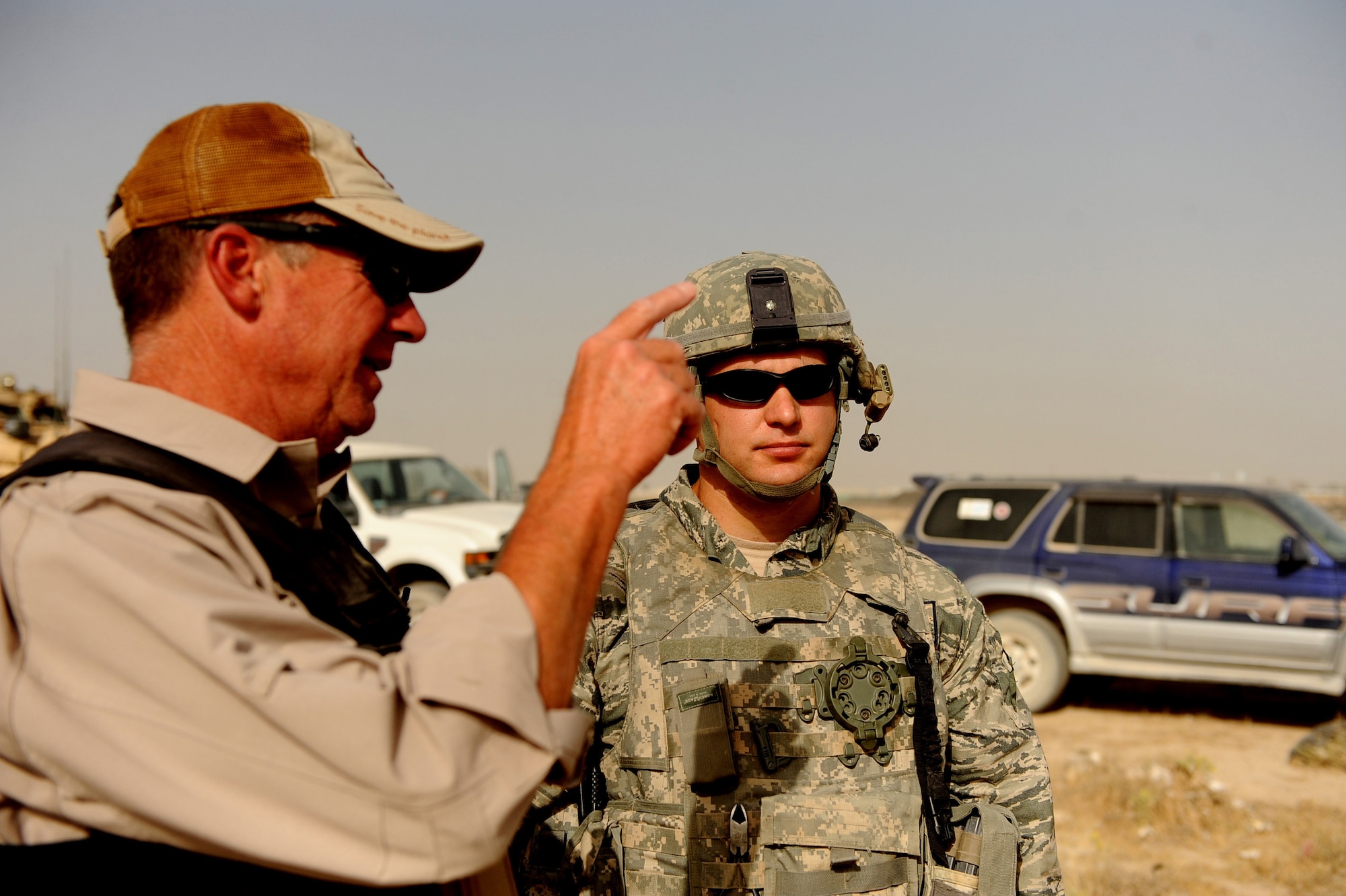 Lee Thompson, an Environmental Chemical Corporation contractor, discuses the day's bomb-clearing mission with Tech. Sgt. David Niedzwiakdek, an explosive ordnance disposal technician assigned to the 755th Air Expeditionary Squadron, Operating Location-Bravo EOD June 4, 2010,  in Kandahar City, Afghanistan. Eight teams of Afghan de-miners working with the Army Corps of Engineers, have uncovered more than 500 munitions including M-42 bomblets, 120 mm rockets, rocket-propelled grenades, 105 mm projectiles and 82 mm mortars. Once the Afghan de-miners uncover the various munitions, 755th OL-B EOD technicians are called in to destroy them.  (U.S. Air Force photo/ Staff Sgt. Manuel J. Martinez/released)


