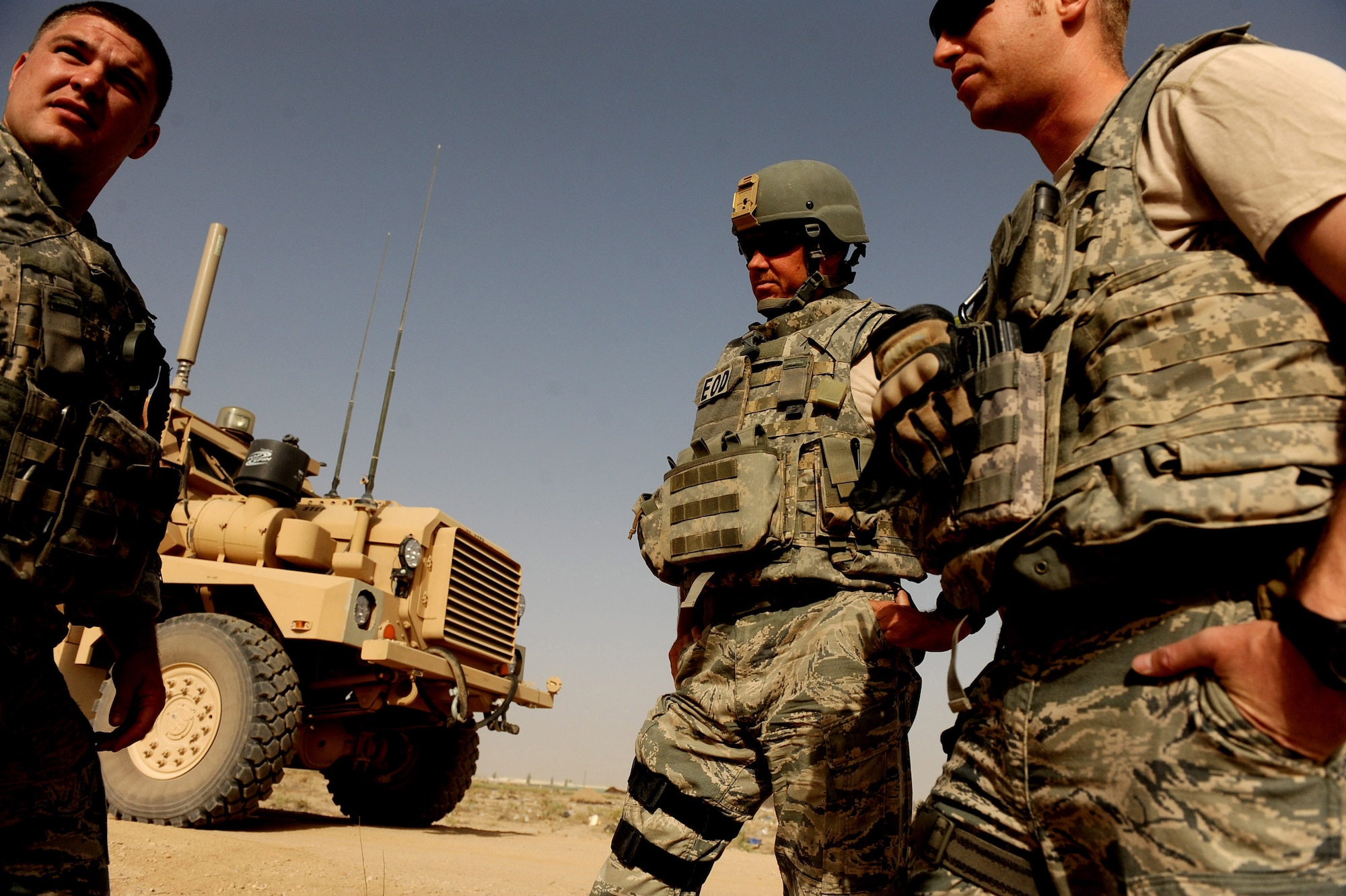 Left to right, Tech. Sgt. David Niedzwiadek, Master Sgt. Donald Moore and Capt. Andrew Clemmensen, all explosive ordnance disposal technicians assigned to the 755th Air Expeditionary Squadron, Operating Location-Bravo, EOD, speak about the day's mission June 4, 2010, in Kandahar City, Afghanistan. (U.S. Air Force photo/ Staff Sgt. Manuel J. Martinez/released)