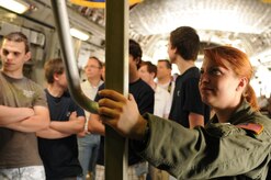 Staff Sgt. Leah Farias, 17th Airlift Squadron loadmaster from Joint Base Charleston, S.C., waits for people to come down from a C-17 Globemaster III’s cockpit during the ILA 2010 Berlin International Aerospace Exhibition and Conferences June 9 at the Berlin-Schoenefeld Airport. (U.S. Air Force photo/Staff Sgt. Julius Delos Reyes)