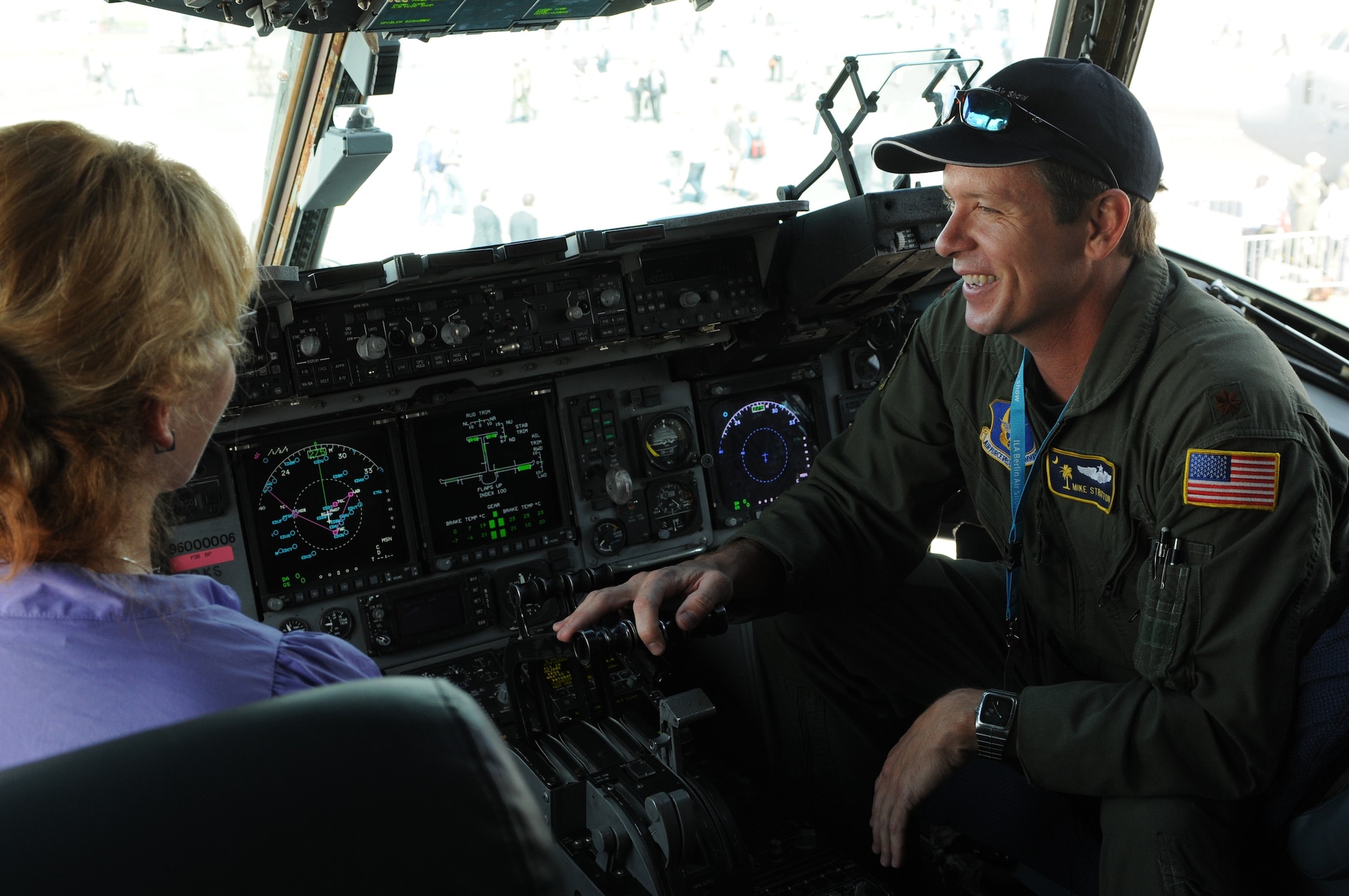 Maj. Mike Stratton, 317th Airlift Squadron instructor pilot from Charleston Air Force Base, S.C., talks about the C-17 Globemaster III’s cockpit to a visitor during the ILA 2010 Berlin International Aerospace Exhibition and Conferences June 9 at the Berlin-Schoenefeld Airport. (U.S. Air Force photo/Staff Sgt. Julius Delos Reyes)