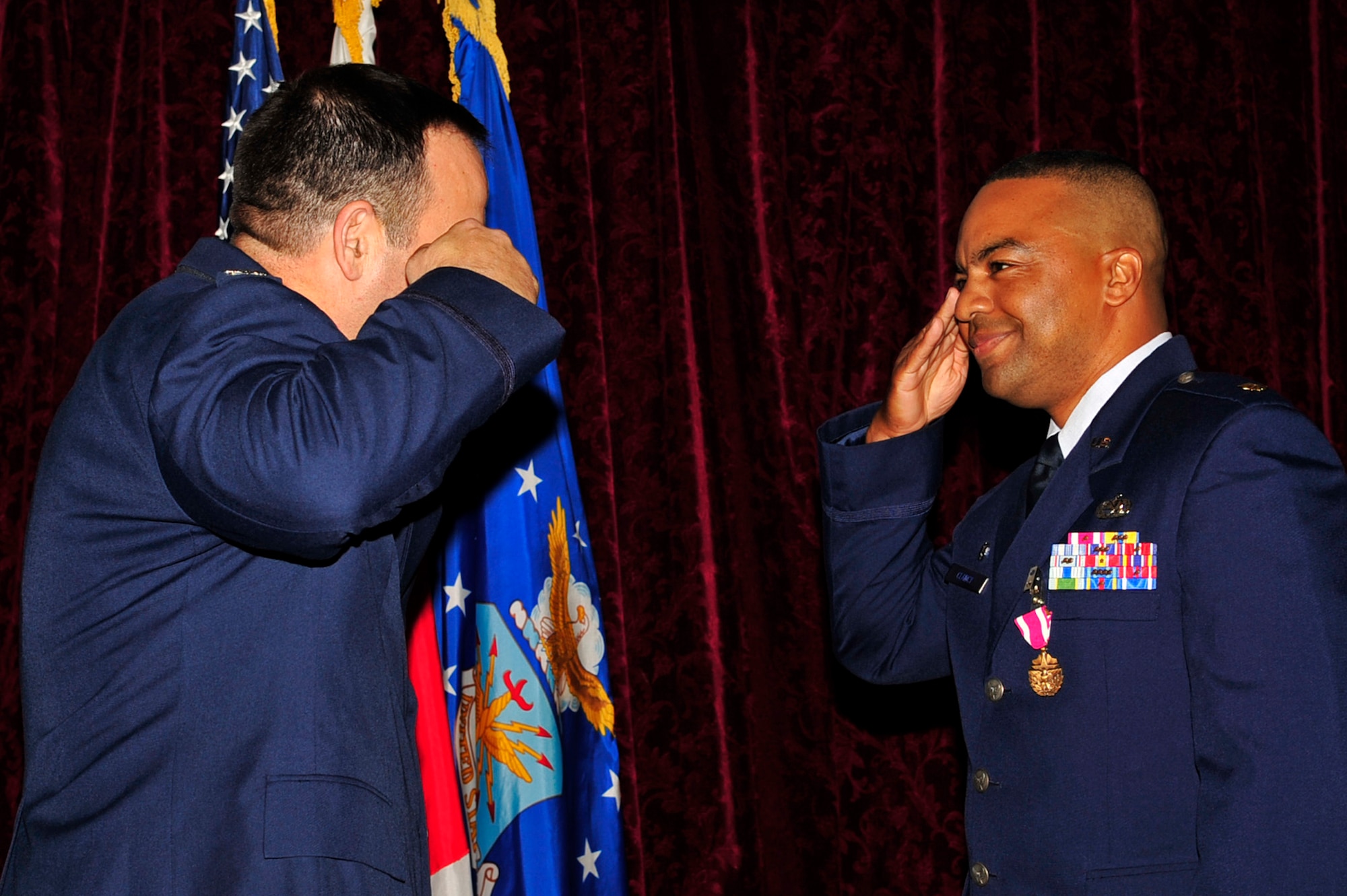 Maj. Michael Clancy relinquishes command after passing the 18th Component Maintenance Squadron guidon to Col. David Brown, 18th Maintenance Group commander, during the change of command ceremony June 10. The major was awarded the Meritorous Service Medal for his contributions at Kadena. (U.S. Air Force photo/Senior Airman Amanda Grabiec)