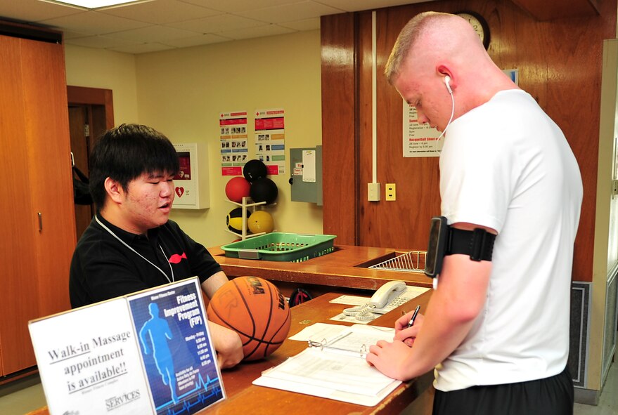 Ryo Oshiro hands out a basketball to a customer at the Risner gym, June 10. Oshiro belongs to an internship program from Kagamigaoka Special Education School. The program offers academic and career counseling for special needs students to become independent and participate in society for life after graduation. Oshiro hopes to attend school in the U.S. to study aerodynamics after graduation. (U.S. Air Force photo/Tech. Sgt. Rey Ramon)