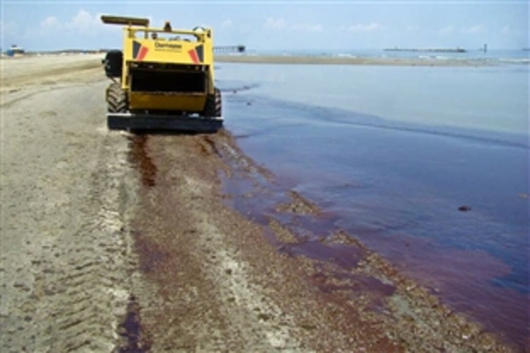 Crews aboard beach clean-up vehicles sift oil on the southeast Louisiana shoreline in Houma, La., June 10, 2010. Thousands of crews using spill-response technology as part of the nation's largest oil spill recovery effort following the BP Deepwater Horizon oil spill, are spread throughout the Gulf area to battle the spill. 

