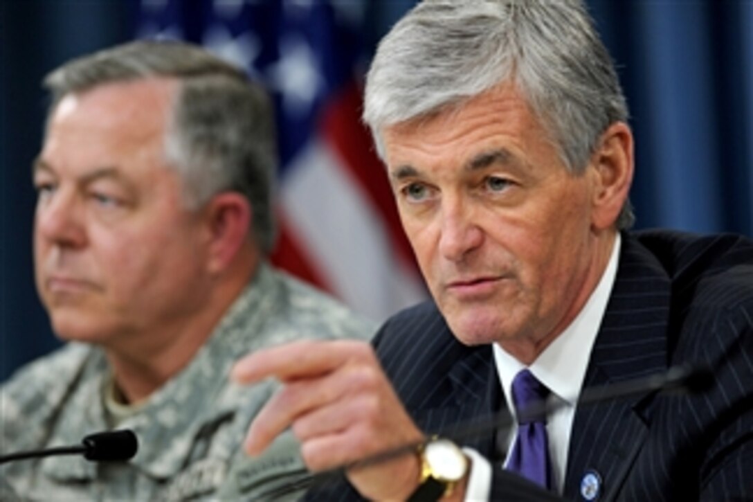 Secretary of the Army John M. McHugh (right) holds a Pentagon press conference to address problems of inappropriate practices and mismanagement at Arlington National Cemetery on June 10, 2010.  The investigation was conducted by Lt. Gen. R. Steven Whitcomb (left), the Army inspector general, and his staff.  