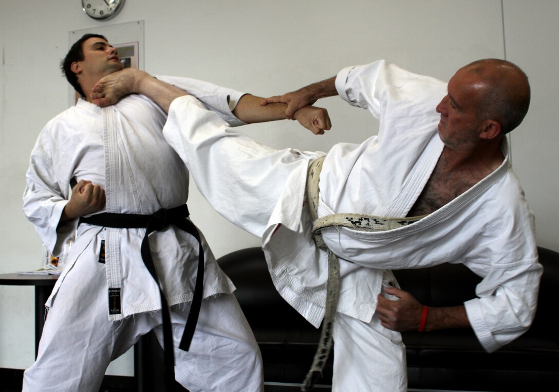 Falah Kanani, chief instructor (Right),  Japan Karate Association of San Diego, and John Gierach, practice their demonstration before the Martial Arts Expo on the depot, June 11. The two martial artists execute a series of moves that are based on a one-blow finish. The focus includes punching, kicking, striking, sweeps and kick-downs.