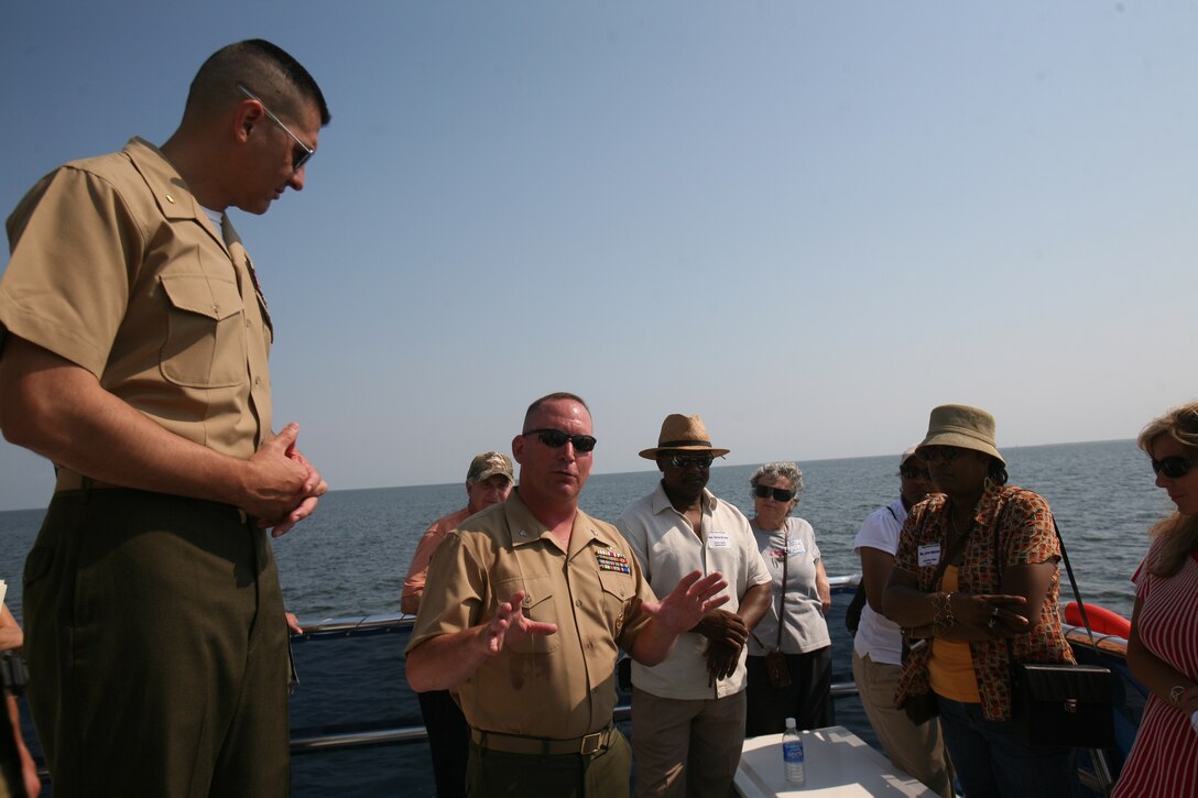 Col. Douglas A. Denn, commanding officer of Marine Corps Air Station Cherry Point, addresses community members from a tour boat during a demonstration at the air station’s Bombing Target 11 range, June 12. “Hopefully today we’ll be able to communicate our needs and capabilities with respect to the air station and national security, and spend a day on the water with some friends,” Denn said.