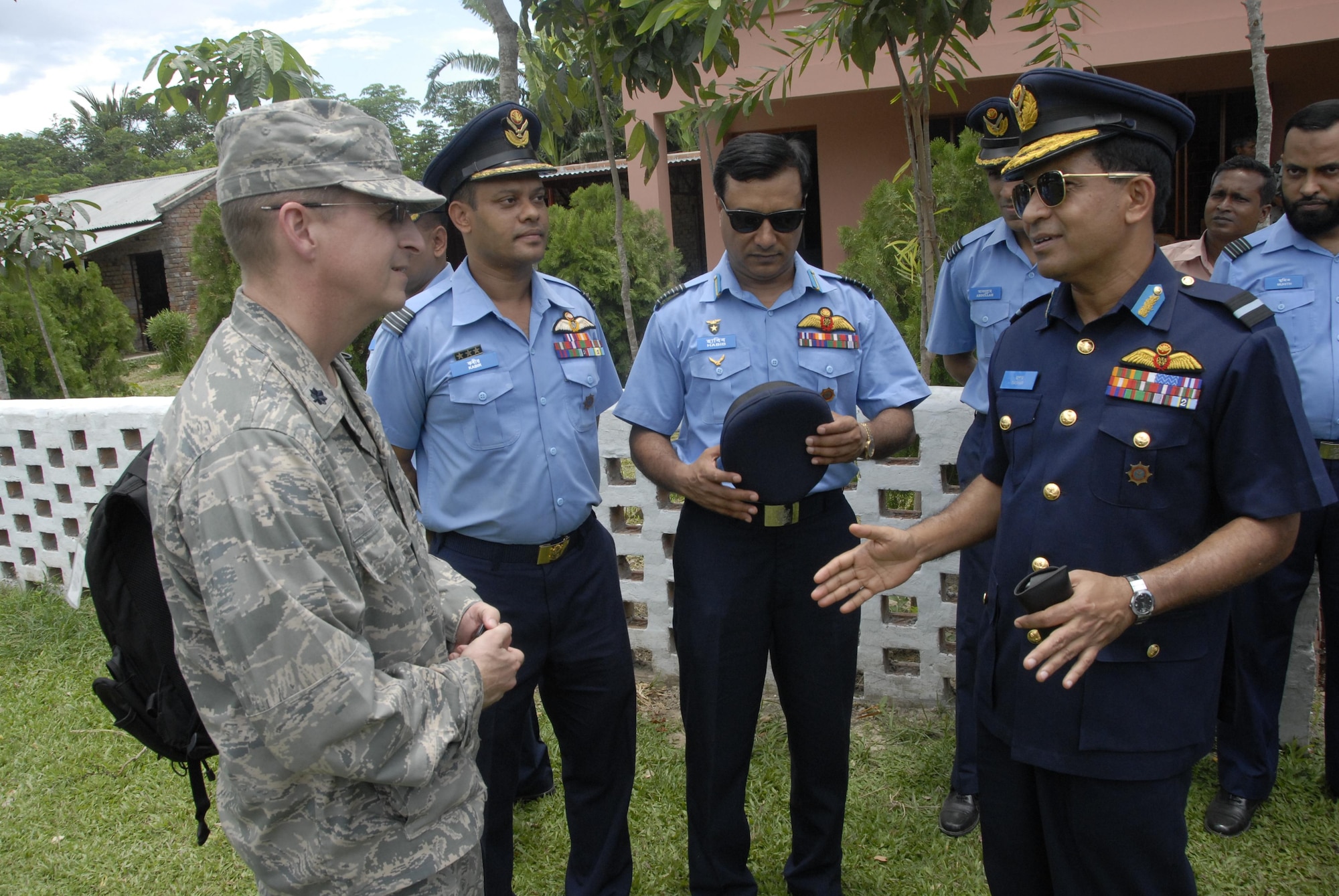 Lt. Col. Scott Long (left), the Operation Pacific Angel mission commander from 13th Air Force at Joint Base Pearl Harbor Hickam, Hawaii, discusses the mission's operations with Air Commodore M. Abul Bashar, of the Bangladesh Air Force, at the Lauri High School and Primary School in Shyamkur Township near Jessore, Bangladesh, on June 12, 2010. Operation Pacific Angel is a joint and combined humanitarian assistance operation conducted in the Pacific area of responsibility to support U.S. Pacific Command's capacity-building efforts. This humanitarian and civic assistance program is aimed at improving military civic cooperation between the United States and countries throughout the Asia-Pacific region. More than 55 U.S. military personnel are participating in civil and medical assistance programs with the help of the Bangladesh Air Force and local nongovernmental organizations. Medical care for Bangladesh citizens will include: primary care, women's health, dental and optometry. Several classrooms are being refurbished as part of the mission at the Lauri High School and Primary School. The operation is scheduled through June 16, 2010. (U.S. Air Force photo/1st Lt. Chris Hoyler)