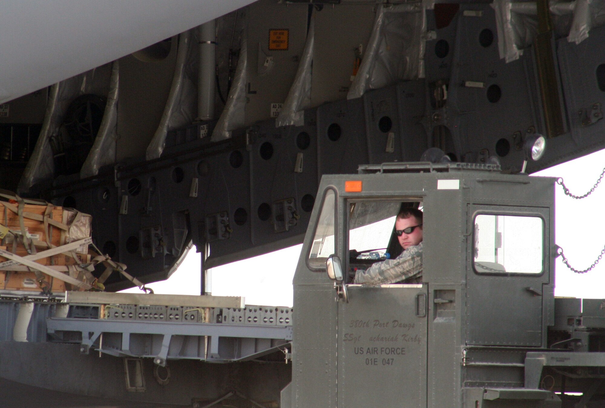 An air transportation Airman from the 380th Expeditionary Logistics Readiness Squadron's Air Terminal Operations Center drives a 60,000-pound-capable aircraft loader to unload a plane during operations for the 380th Air Expeditionary Wing at a non-disclosed base in Southwest Asia on  May 19, 2010. The 380th AEW supports operations Iraqi Freedom and Enduring Freedom and the Combined Joint Task Force-Horn of Africa. All air transportation Airmen deployed with the 380th AEW are deployed from the 89th Aerial Port Squadron at Joint Base Andrews, Md. (U.S. Air Force Photo/Master Sgt. Scott T. Sturkol/Released)