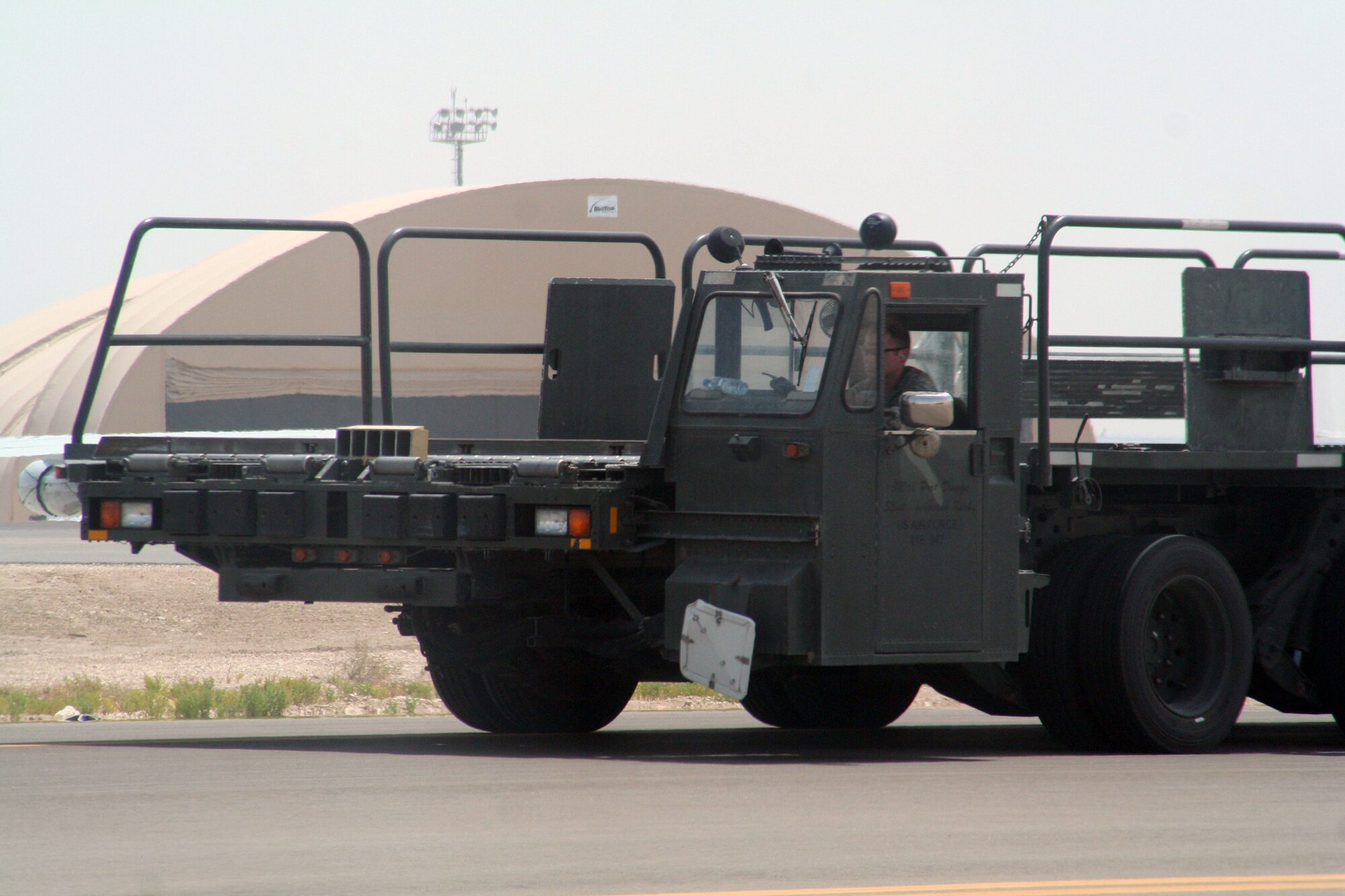 An air transportation Airman from the 380th Expeditionary Logistics Readiness Squadron's Air Terminal Operations Center drives a 60,000-pound-capable aircraft loader to unload a plane during operations for the 380th Air Expeditionary Wing at a non-disclosed base in Southwest Asia on  May 19, 2010. The 380th AEW supports operations Iraqi Freedom and Enduring Freedom and the Combined Joint Task Force-Horn of Africa. All air transportation Airmen deployed with the 380th AEW are deployed from the 89th Aerial Port Squadron at Joint Base Andrews, Md. (U.S. Air Force Photo/Master Sgt. Scott T. Sturkol/Released)