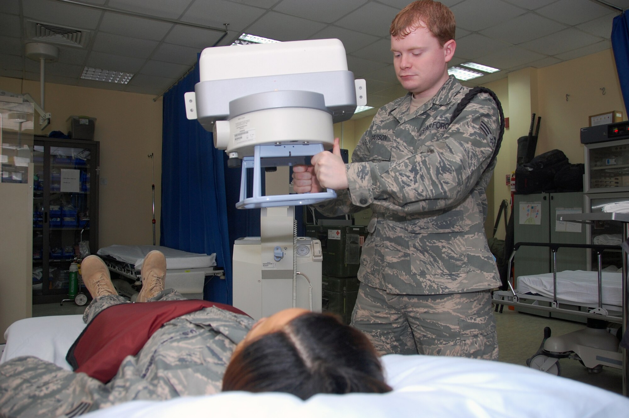 U.S. Air Force Senior Airman Robert Davison, 386th Expeditionary Medical Group radiology technician, assists a patient June 12, 2010 at an air base in Southwest Asia. Airman Davison is deployed from Eglin Air Force Base, Fla. (U.S. Air Force photo by Staff Sgt. Lakisha A. Croley/Released)