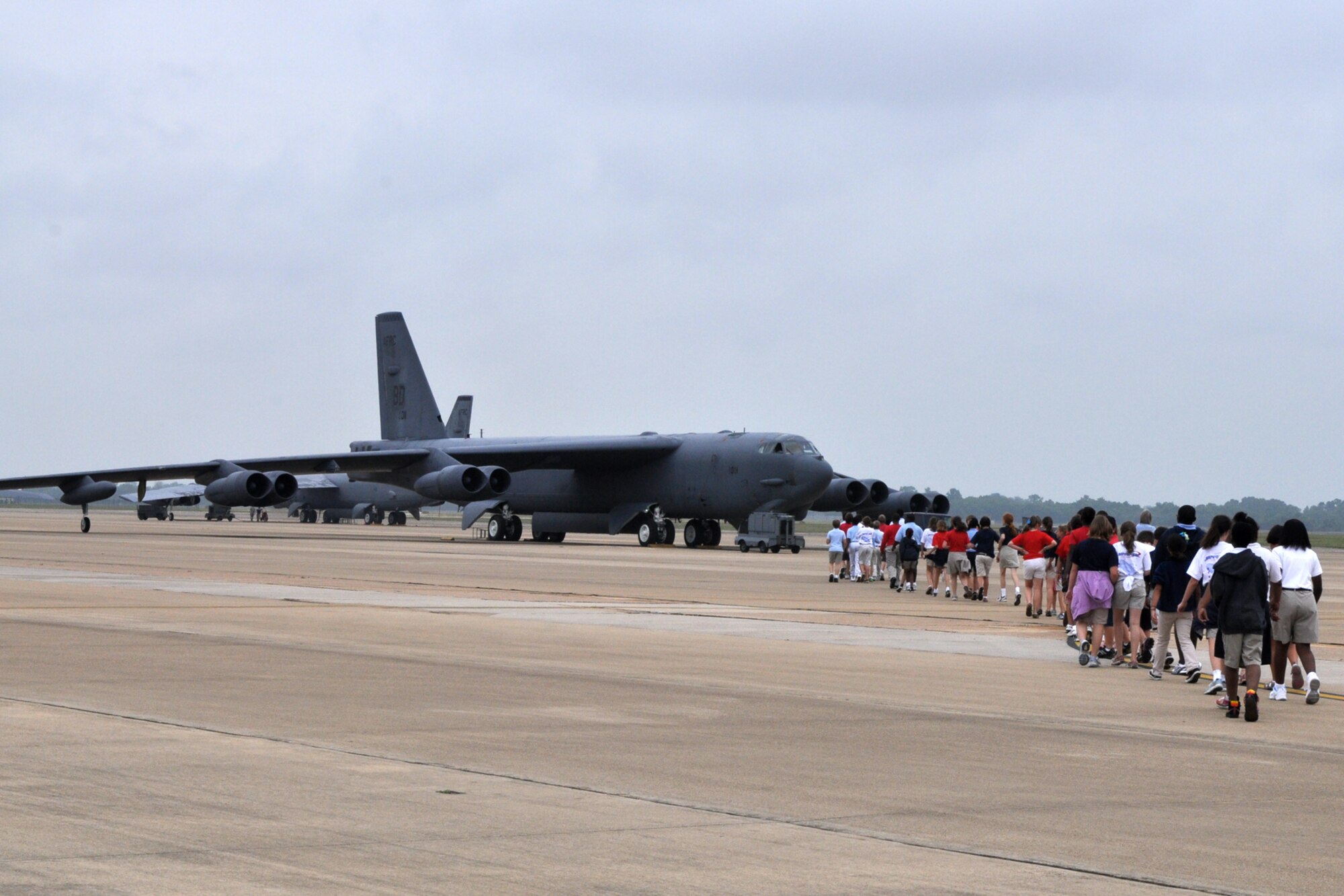 Fifth graders from Shreve Island Elementary School, Shreveport, La., make their way to a B-52 Stratofortress for briefings on the history and capabilities of the jet bomber from 1st Lt. Billy McNair and 2nd Lt. Amie Hacker, on the ramp at Barksdale Air Force Base, La., June 10, 2010. These students comprise the last class for the school year from STARBASE Louisiana, to visit a B-52 at Barksdale. STARBASE Louisiana, one of 60 national STARBASE sites, is sponsored by the 917th Wing of the Air Force Reserve Command. The program presents an exciting 25-hour hands on/minds on aviation and aerospace curriculum to area 5th grade students and their teachers. Lieutenants McNair and Hacker volunteered to spend an hour with the fifth graders to encourage them to continue their education and grasp for the stars. Both Lieutenants are assigned to the 11th Bomb Squadron, but are currently attending the B-52 formal training unit (FTU) at the 93rd Bomb Squadron, which is part of the 917th Wing at Barksdale. Lieutenant McNair is presently a pilot student here and calls Las Cruses, N.M. home. He plans to stay at Barksdale with the 96th Bomb Squadron after graduation. Lieutenant Hacker is presently a navigator student and claims Oklahoma City, Okla., as her hometown. She plans to transfer to Minot Air Force Base, N.D., after graduation. (U.S. Air Force photo/Tech. Sgt. Jeff Walston)  
