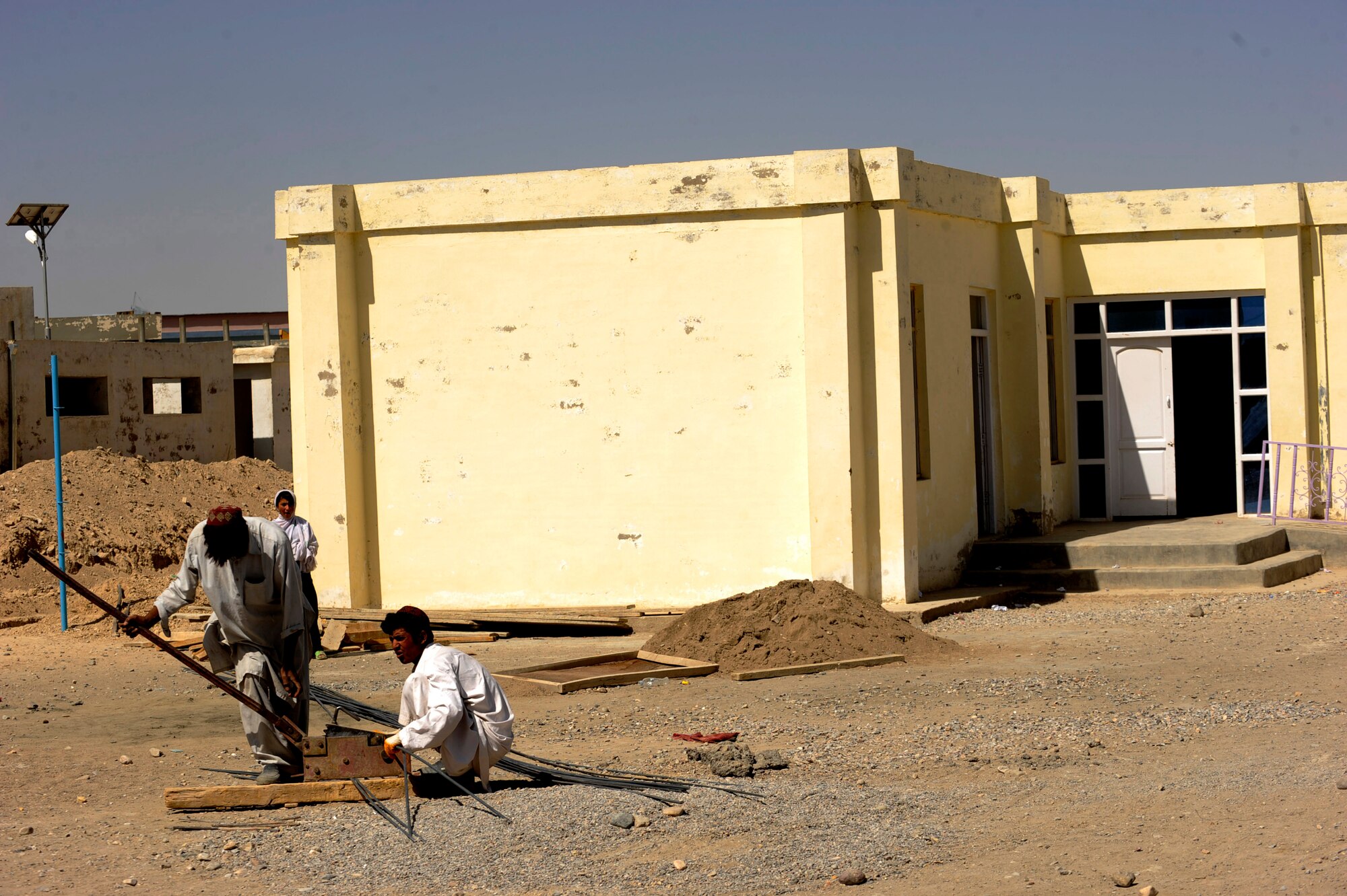 Afghans work with metal for an improvement project on the Bibi Khala Girl's School May 31, 2010, in Qalat City, Afghanistan.  (U.S. Air Force photo/Staff Sgt. Manuel J. Martinez/released) 



