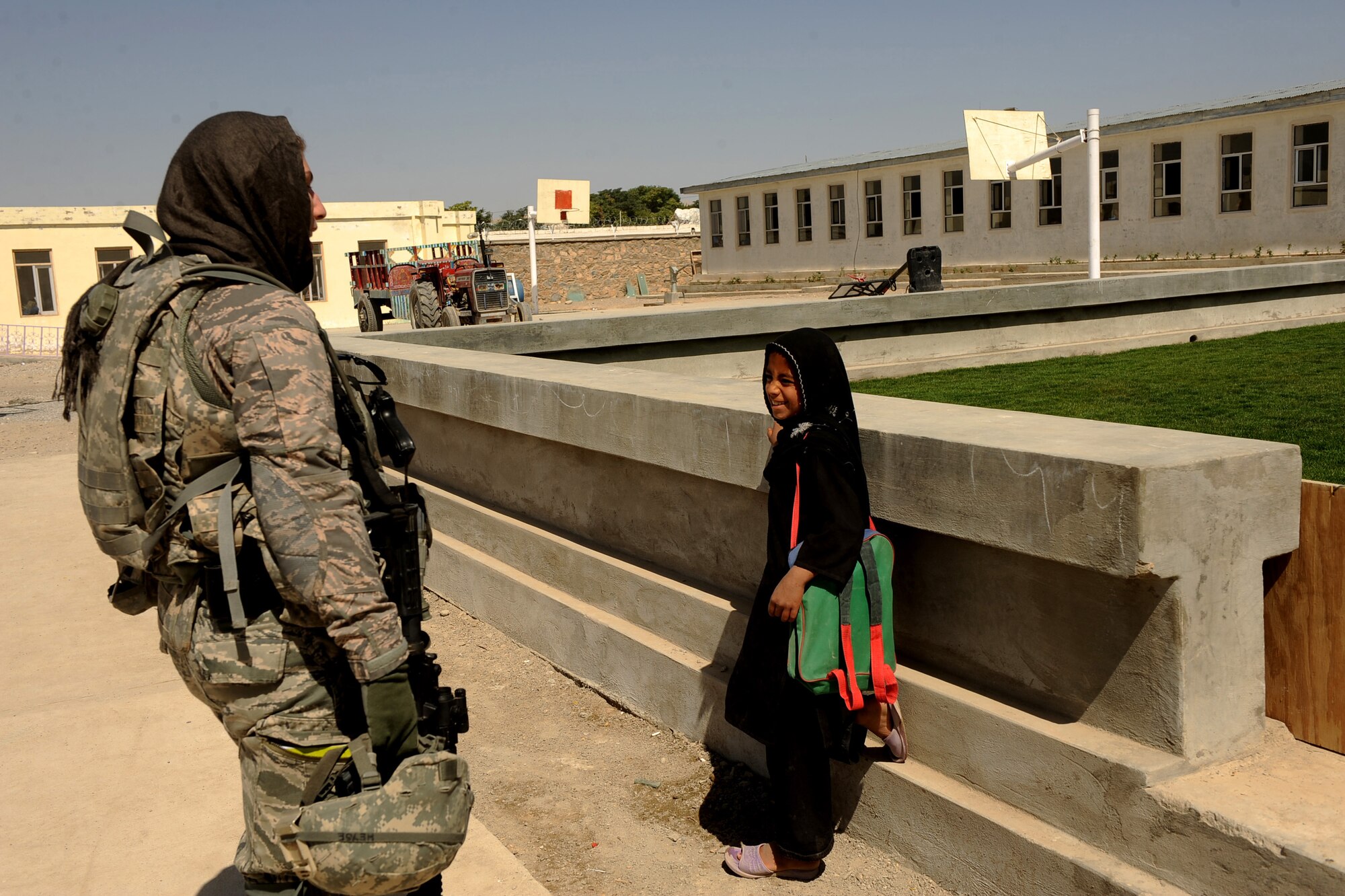 First Lieutenant Rebecca Heyse, information officer assigned to the Provincial Reconstruction Team Zabul, speaks with an Afghan girl at the Bibi Khala Girl's School, during a visit to check the progress of improvement projects at the school   May 31, 2010, in Qalat City, Afghanistan.  (U.S. Air Force photo/Staff Sgt. Manuel J. Martinez/released) 
