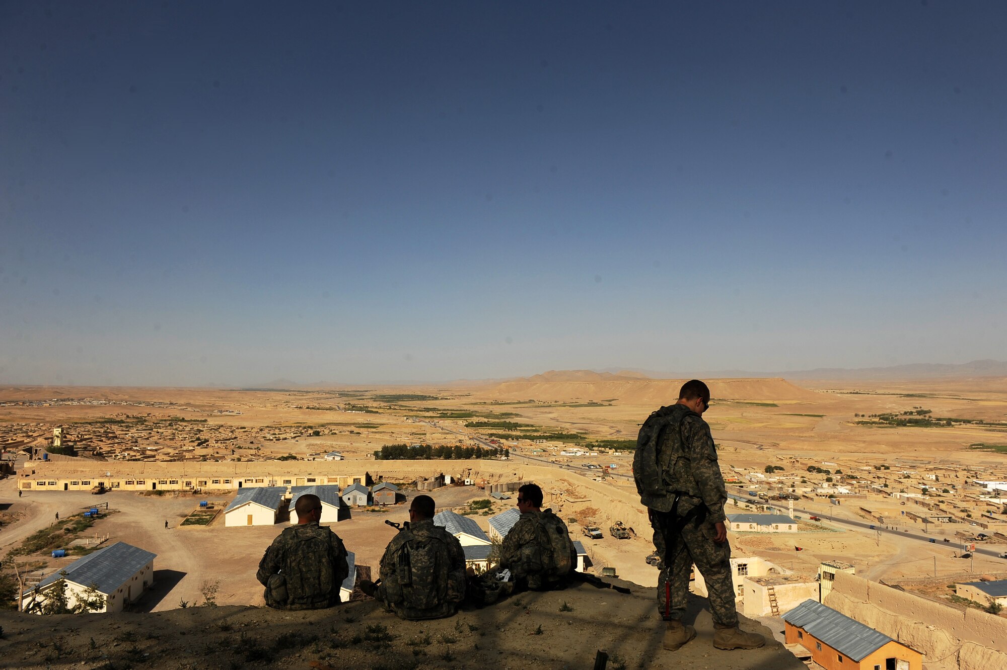 U.S. Soldiers, part of a security forces team assigned to Provincial Reconstruction Team Zabul, sit on the highest part of ?The Castle? and discuss different vantage points May 31, 2010, in Qalat City, Afghanistan. Soldiers hope to use the stone structure, towering over the more than 10,000 inhabitants of Qalat City, to help the PRT fulfill its three goals - improve security, extend the authority and credibility of the Afghan government and facilitate reconstruction. (U.S. Air Force photo/Staff Sgt. Manuel J. Martinez/released) 

