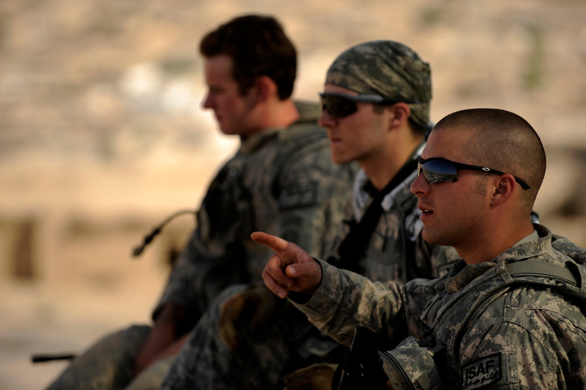 Army Specialist Trevor Soltis, a generator mechanic assigned to Provincial Reconstruction Team Zabul, points out objects in the distance from the highest point of ?The Castle? May 31, 2010, in Qalat City, Afghanistan.  (U.S. Air Force photo/Staff Sgt. Manuel J. Martinez/released) 
