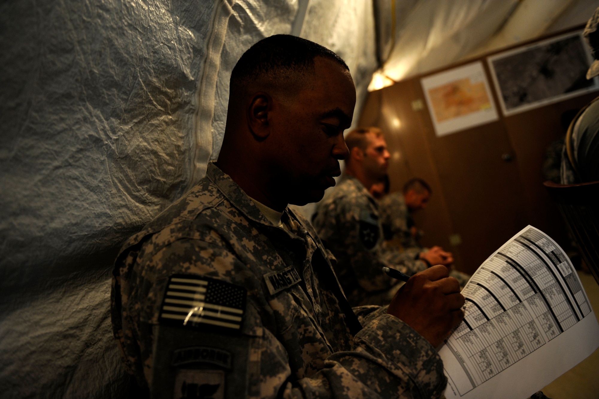 Army Staff Sgt. Clarence Washington, Provincial Reconstruction Team Zabul third squad security forces lead, performs roll call for people listed on the mission orders for the day's mission May 31, 2010, at Forward Operating Base Smart, Afghanistan. ?I am not the first Soldier to walk up the hill to use ?The Castle? for military purposes and I probably won?t be the last,? Sergeant Washington said.  He is deployed from the Pennsylvania National Guard?s 110th Infantry Battalion in Connellsville, Pa. ?Hopefully we can use its vantage point to secure our operations in this Province.? (U.S. Air Force photo/Staff Sgt. Manuel J. Martinez/released) 

