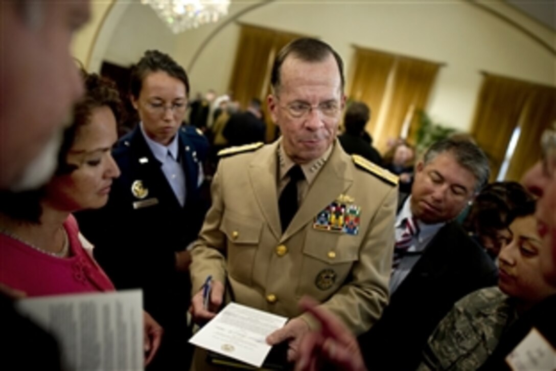 Navy Adm. Mike Mullen, chairman of the Joint Chiefs of Staff, greets audience members following a town hall meeting at the University of Southern California in Los Angeles, June 11, 2010.