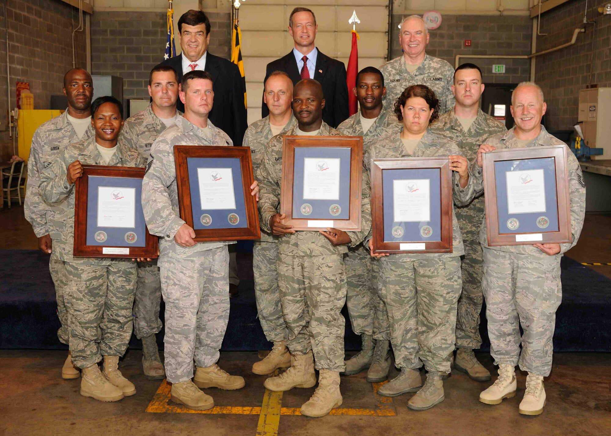 Rep. Dutch Ruppersberger (left), Maryland Gov. Martin O’Malley (center) and Brig. Gen. James Adkins, the adjutant general of Maryland (far right), pose with a group of Airmen from the Maryland Air National Guard who received awards for their overseas service during a ceremony at Warfield Air National Guard Base, Baltimore, Md., June 13, 2010.  The men and women of the 175th Wing were commended for their service in the Global War on Terrorism over the past ten years. (U.S. Air Force photo by Staff Sgt. Benjamin Hughes/Released)