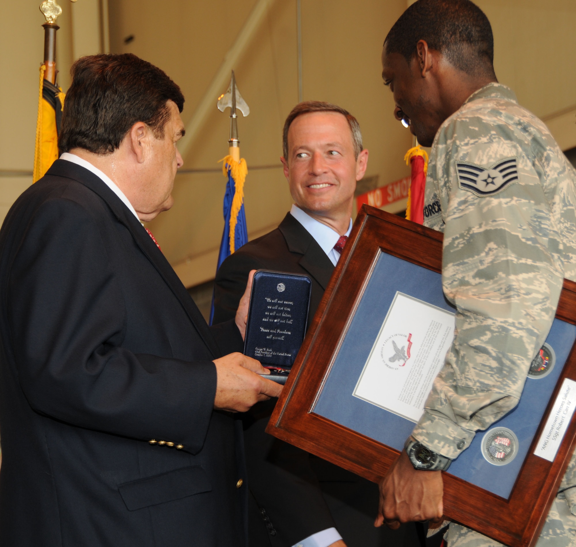 Rep. Dutch Ruppersberger (left) and Maryland Gov. Martin O’Malley (center) recognize Staff Sgt. Robert Carr, 135th Airlift Squadron, for his 2006 overseas service during a ceremony at Warfield Air National Guard Base, Baltimore, Md., June 13, 2010.  The men and women of the 175th Wing were commended for their service in the Global War on Terrorism over the past ten years. (U.S. Air Force photo by Tech Sgt. Chris Schepers/Released) 