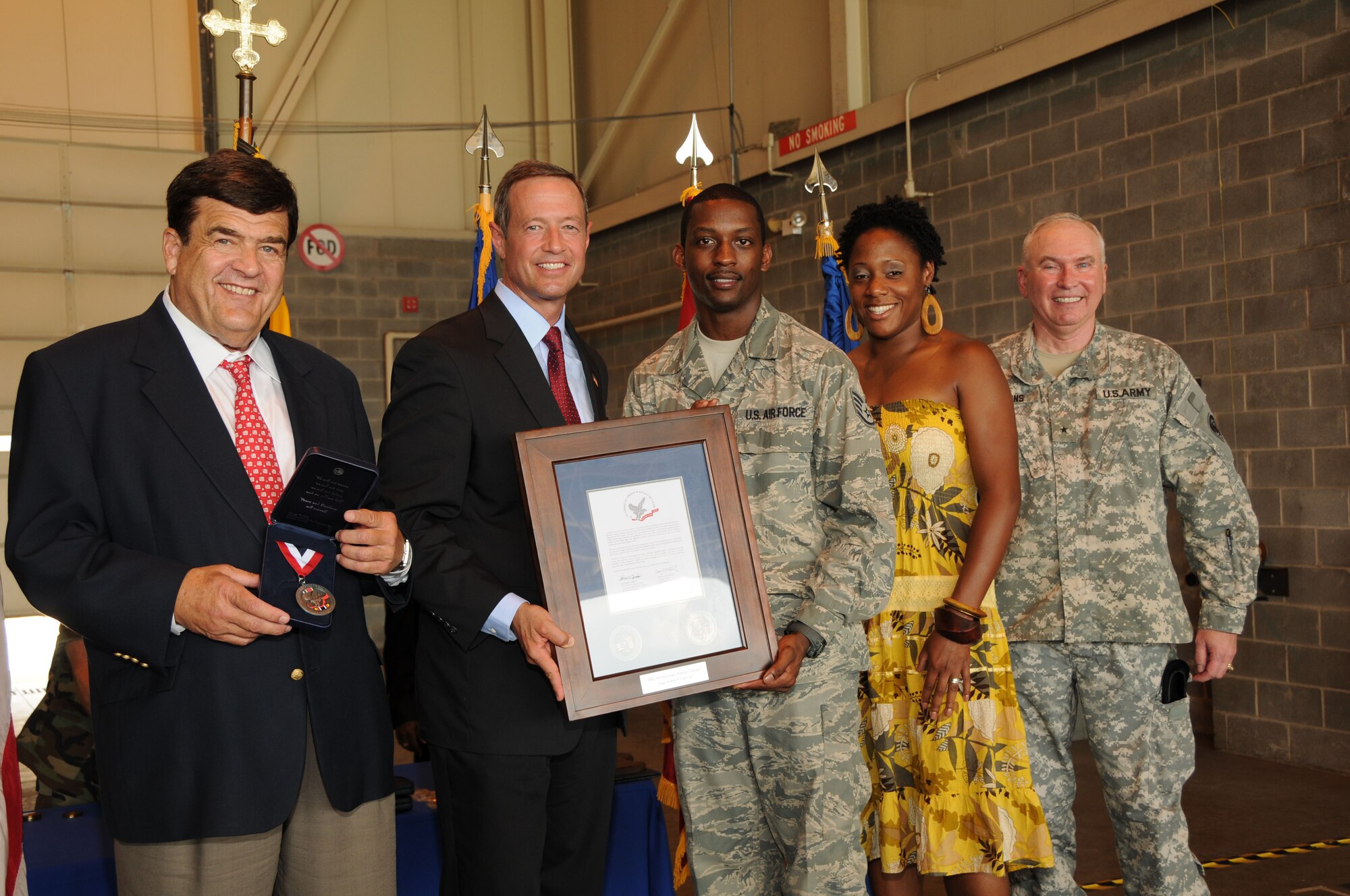 Rep. Dutch Ruppersberger (left), Maryland Gov. Martin O’Malley (center) and Brig. Gen. James Adkins, the adjutant general of Maryland (far right), present Staff Sgt. Robert Carr, 135th Airlift Squadron, with a plaque recognizing his 2006 overseas service during a ceremony at Warfield Air National Guard Base, Baltimore, Md., June 13, 2010.  The men and women of the 175th Wing were commended for their service in the Global War on Terrorism over the past ten years. (U.S. Air Force photo by Tech Sgt. Chris Schepers/Released) 