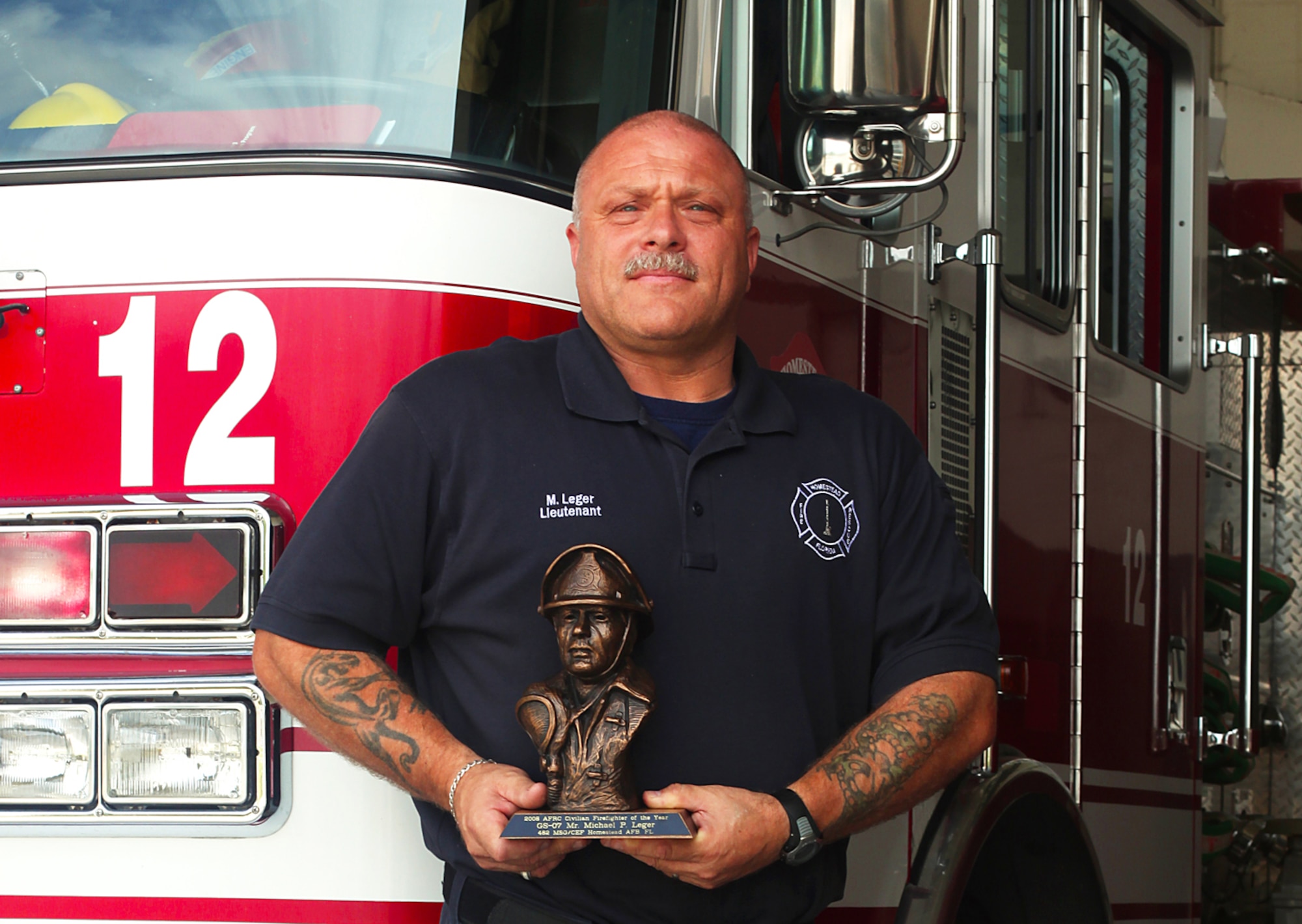 Lieutenant Mike Ledger, Homestead Air Reserve Base Firefighter proudly displays his 2008 Air Force Reserve Command Civilian Firefighter of the Year award. Along with his substantial education and training, Lt. Ledger is credited with saving an estimated $10 million in equipment when he prevented a fire in his building during a construction remodel at Homestead Air Reserve Base in 2006. (U.S. Air Force photo/Senior Airman Lou Burton)