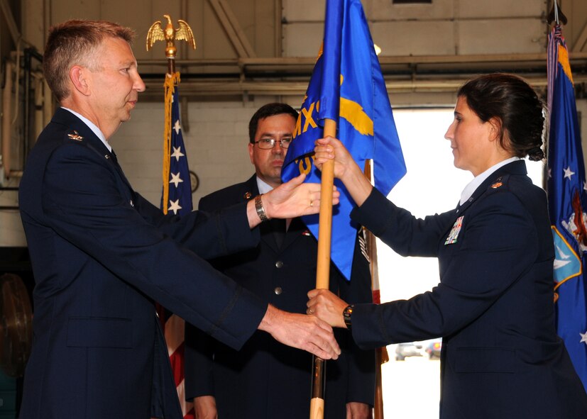 U.S. Air Force Lt. Col. Julie Curlin accepts the guidon of the 135th Maintenance Squadron, Maryland Air National Guard, from U.S. Air Force Col. Thomas Hans during a change of command ceremony at Warfield Air National Guard Base, Baltimore, Md., June 12, 2010.  Col. Curlin was appointed to command the squadron after U.S. Air Force Lt. Col. Salvatore Demarco retired. (U.S. Air Force photo by Staff Sgt. Benjamin Hughes/Released)
