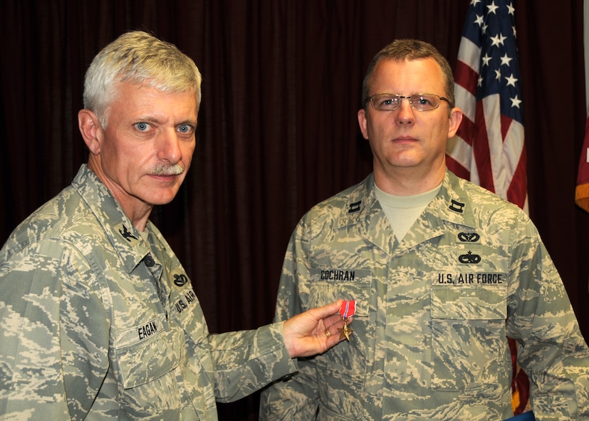 U.S. Air Force Capt. James Cochran of the Maryland Air National Guard receives a Bronze Star Medal from U.S. Air Force Col. Daniel Eagan at Warfield Air National Guard Base, Baltimore, Md., May 15, 2010.  Captain Cochran was awarded a Bronze Star Medal for meritorious service while serving with the 175th Civil Engineer Squadron. (U.S. Air Force photo by Staff Sgt. Benjamin Hughes/Released)