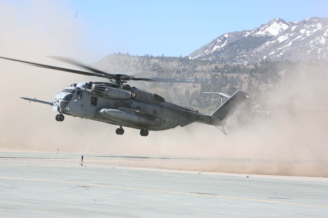 A CH-53E Helicopter with Marine Heavy Helicopter Squadron 772, 4th Marine Aircraft Wing kicks up sand and dust as it prepares to land and begin transporting Marines.::r::::n::::r::::n::HMH 772 is based out of Willow Grove, Penn.
