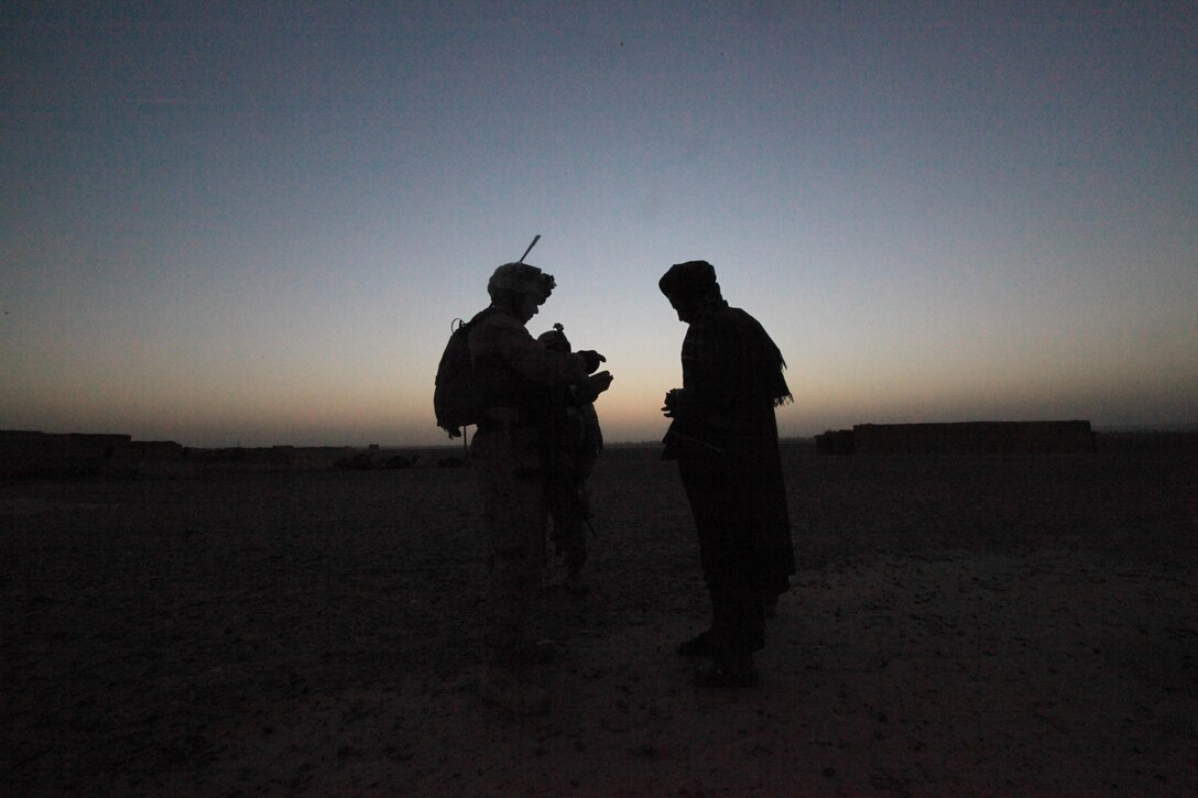 1st Lt. Marcos Ruvalcava, 33, rifle platoon commander for 1st Platoon, Lima Co., 3rd Battalion, 1st Marine Regiment, talks to village elder on the western side of the Helmand River in Garmsir District, Helmand province, Islamic Republic of Afghanistan, June 14, where the Marines want to start making their presence known.