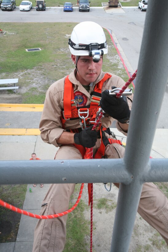 Sgt. Robert C. Cody, training noncommissioned Officer and Rescue Technician with Aircraft Rescue and Firefighters, demonstrates, to the Marines of ARFF, the correct way to repel, June 14. As a training noncommissioned officer Roberts has to keep track of the training records of all ARFF Marines and make sure they are up to date on all their training.