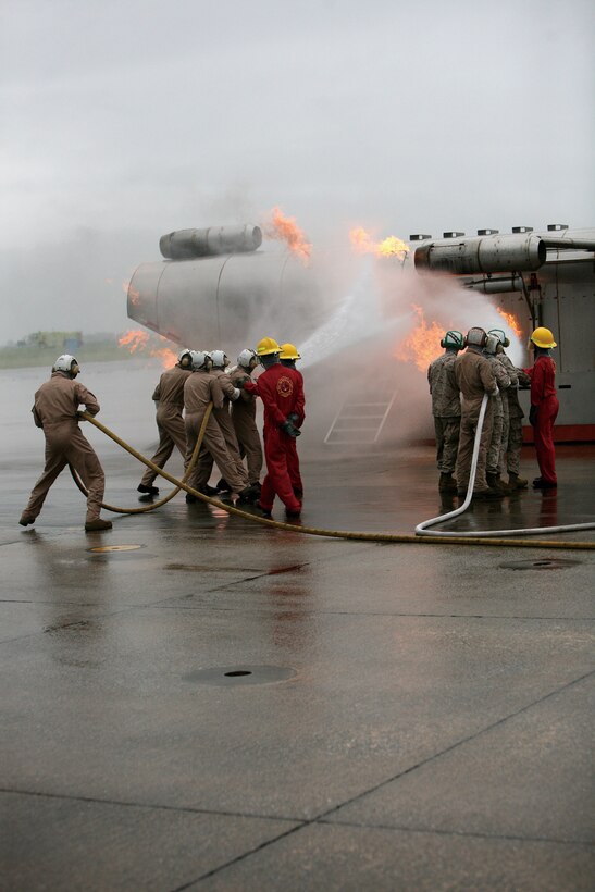 Team one and two practice shipboard fire fighting techniques, June 14. This exercise simulates a class b fire, or field fire.