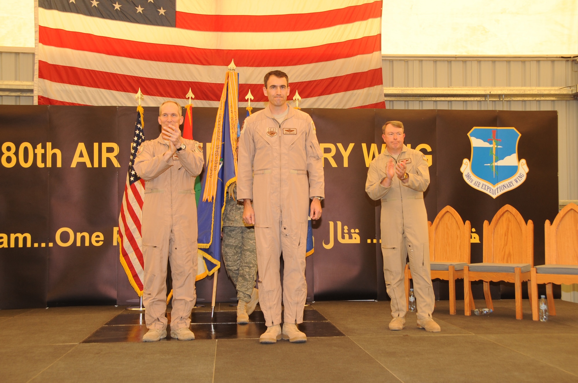 Lt. Gen. Mike Hostage (left), U.S. Air Forces Central Command commander in Southwest Asia, and Brig. Gen Bryan Benson (right), former 380th Air Expeditionary Wing commander, congratulate Col. Mike Minahan, newest 380th AEW commander, after Colonel Minahan took command of the 380th AEW during a change of command ceremony at a non-disclosed base in Southwest Asia on June 14, 2010. (U.S. Air Force Photo/Senior Airman Jenifer H. Calhoun/Released)